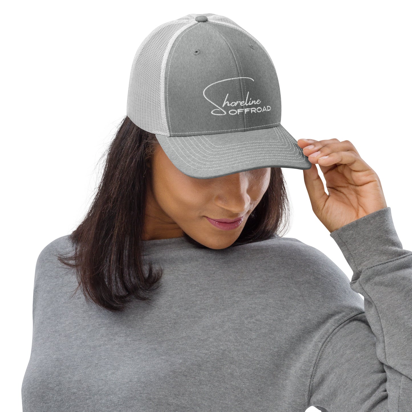 a woman in a gray shirt and a gray hat