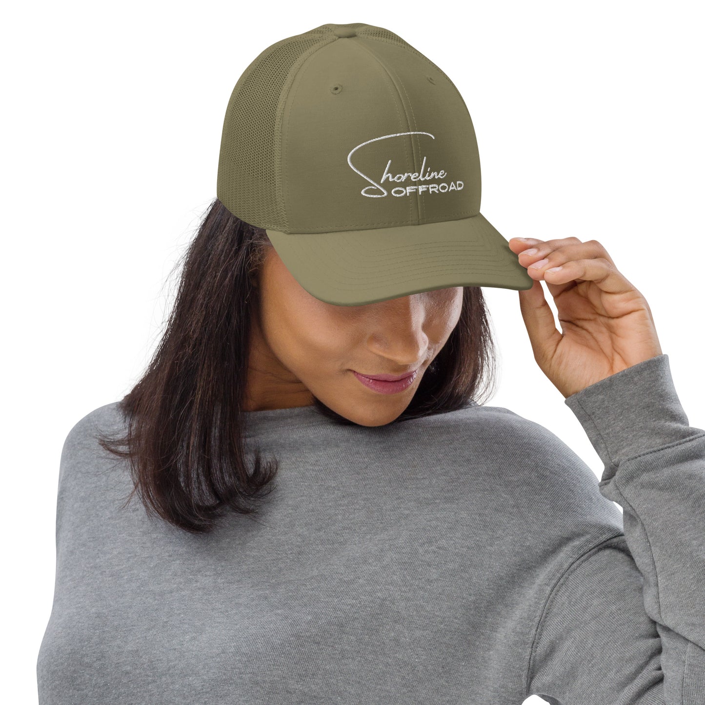 a woman wearing a khaki trucker hat