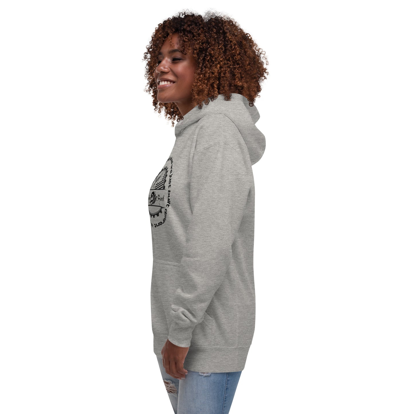 a woman with curly hair wearing a grey hoodie