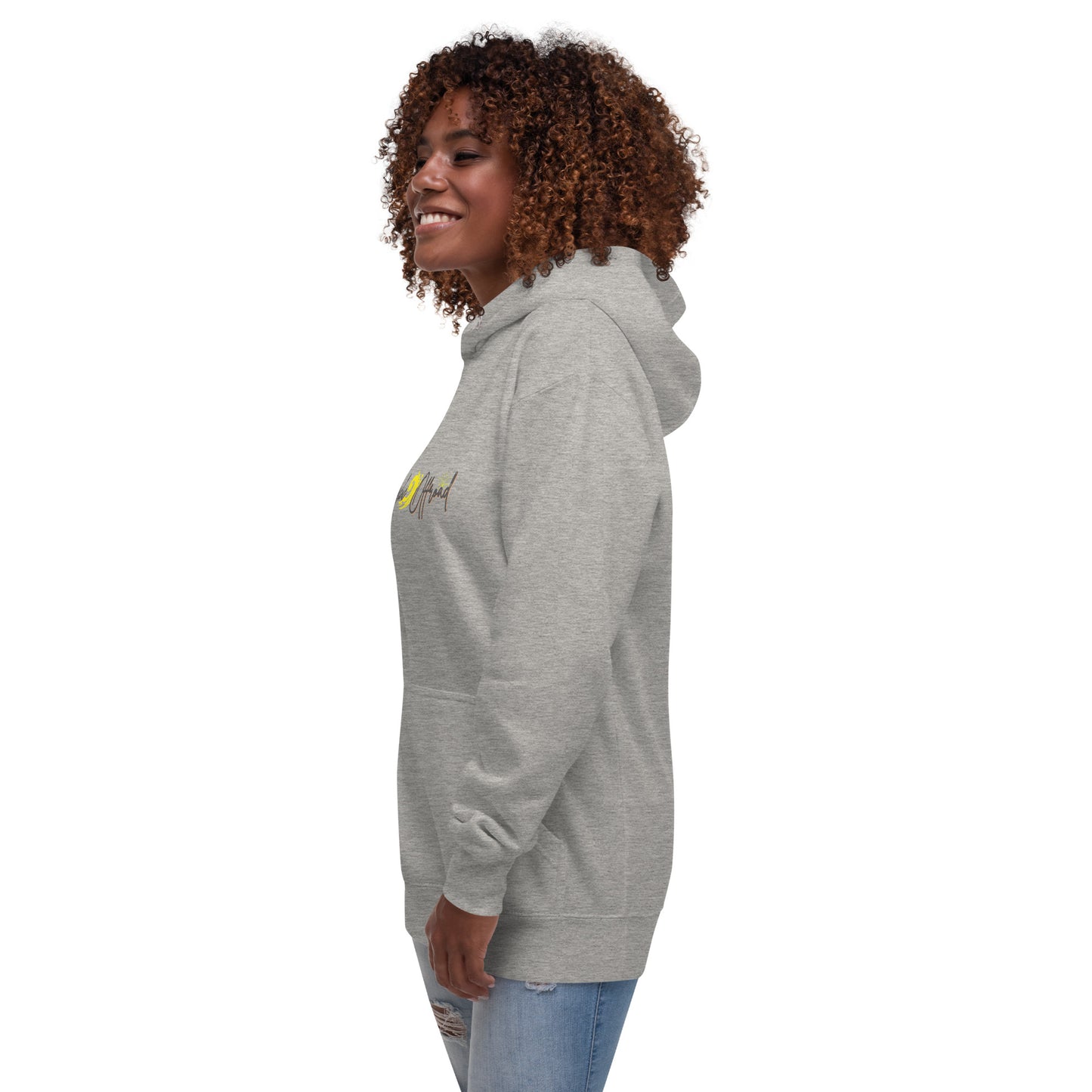 a woman with curly hair wearing a grey hoodie