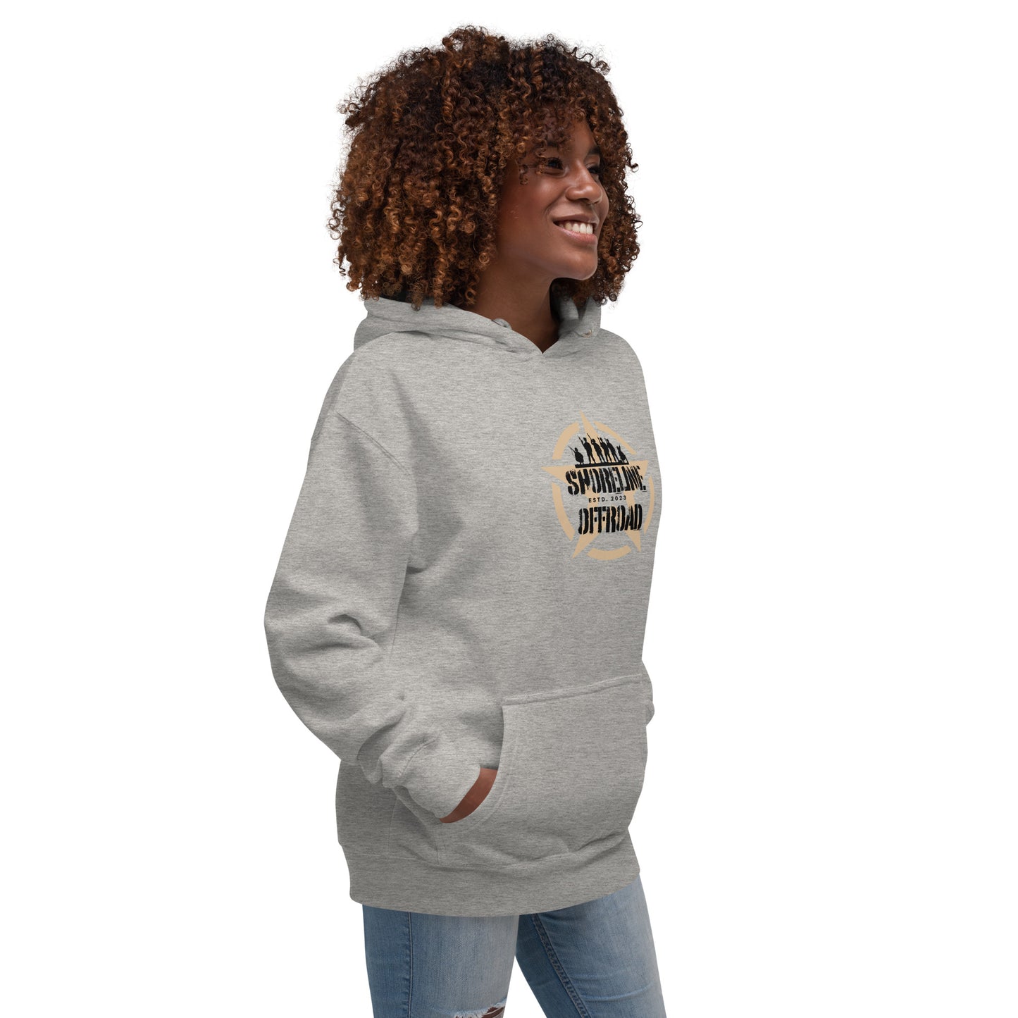 a woman with curly hair wearing a grey hoodie