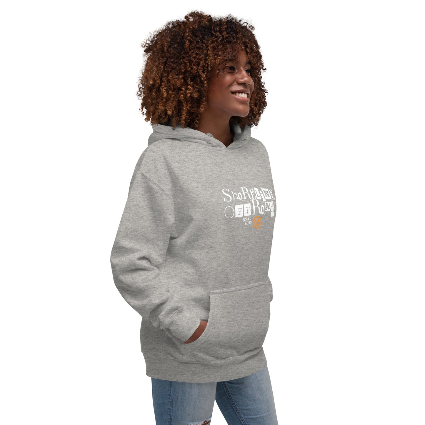 a woman with curly hair wearing a grey hoodie