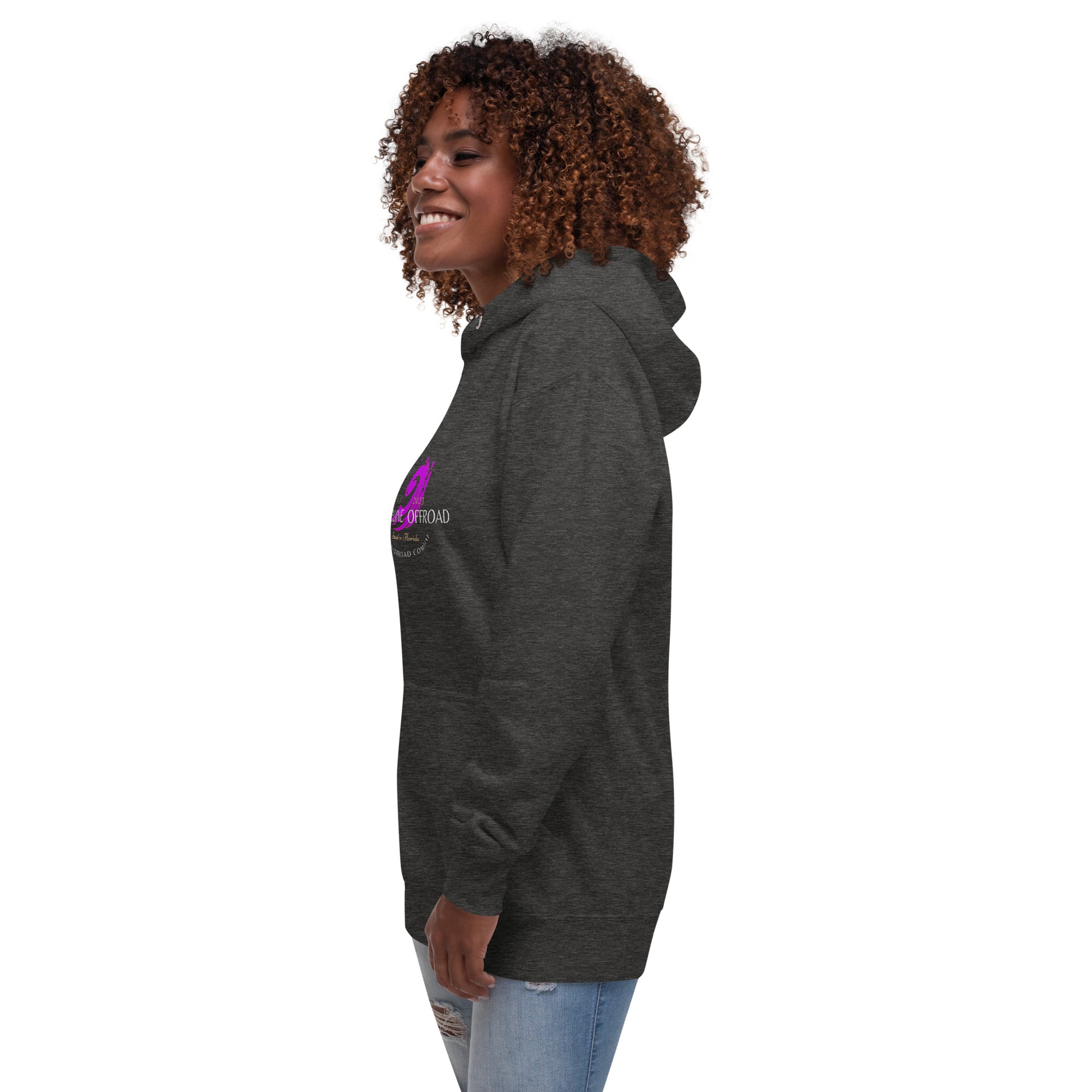 a woman with curly hair wearing a black hoodie