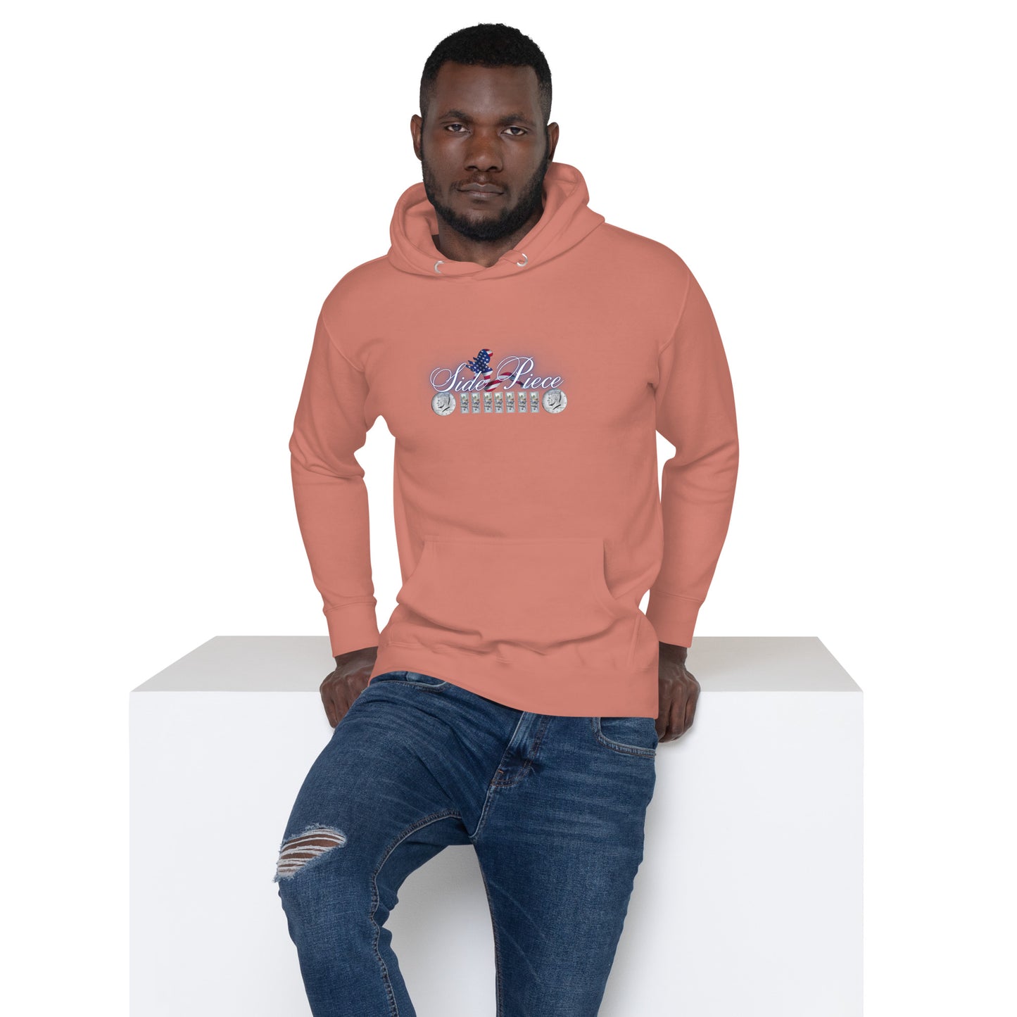 a man sitting on a ledge wearing an orange hoodie