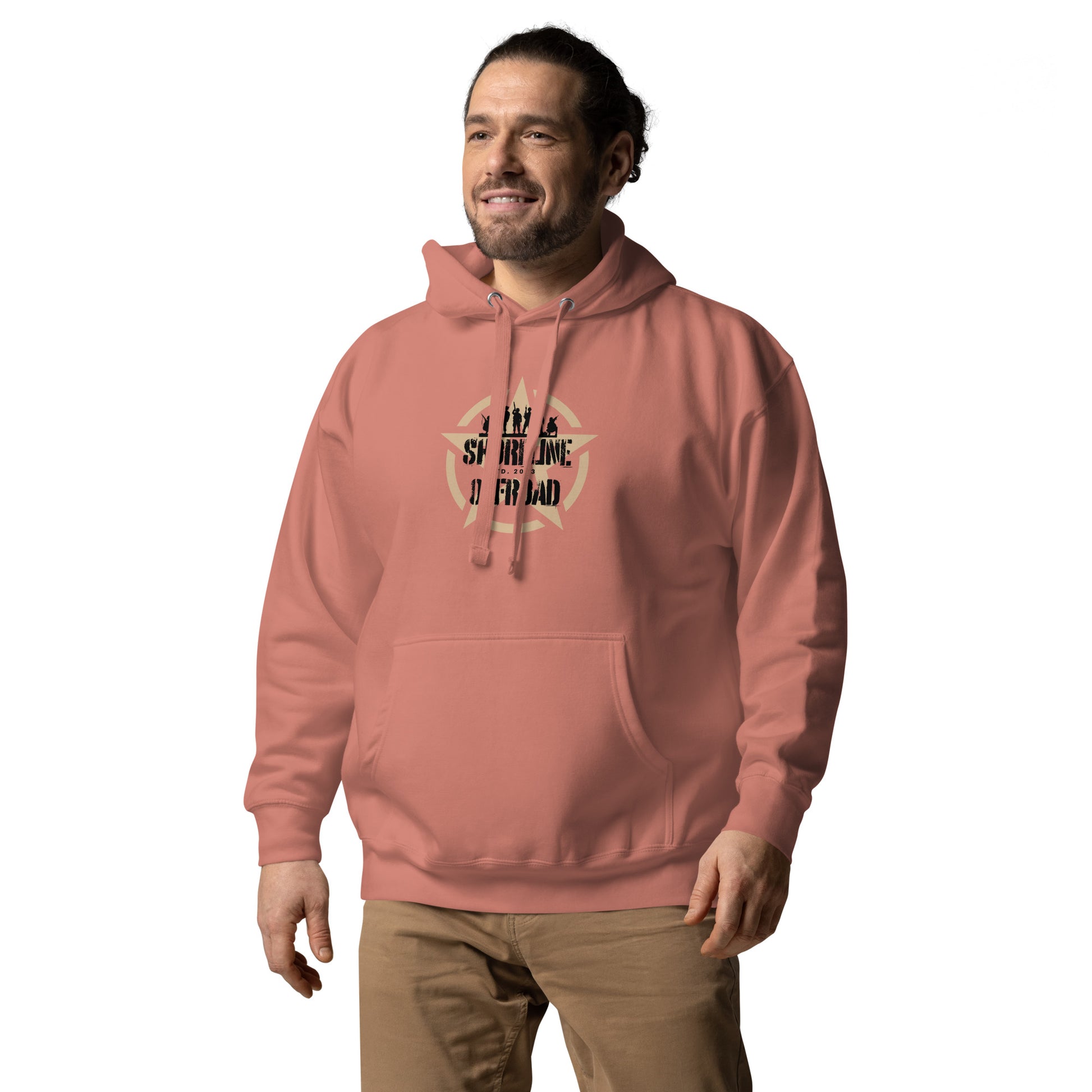 a man wearing a pink hoodie with a quote on it