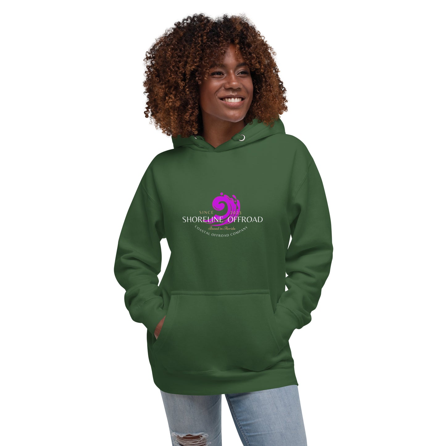 a woman wearing a green hoodie with the logo of a breast cancer awareness organization