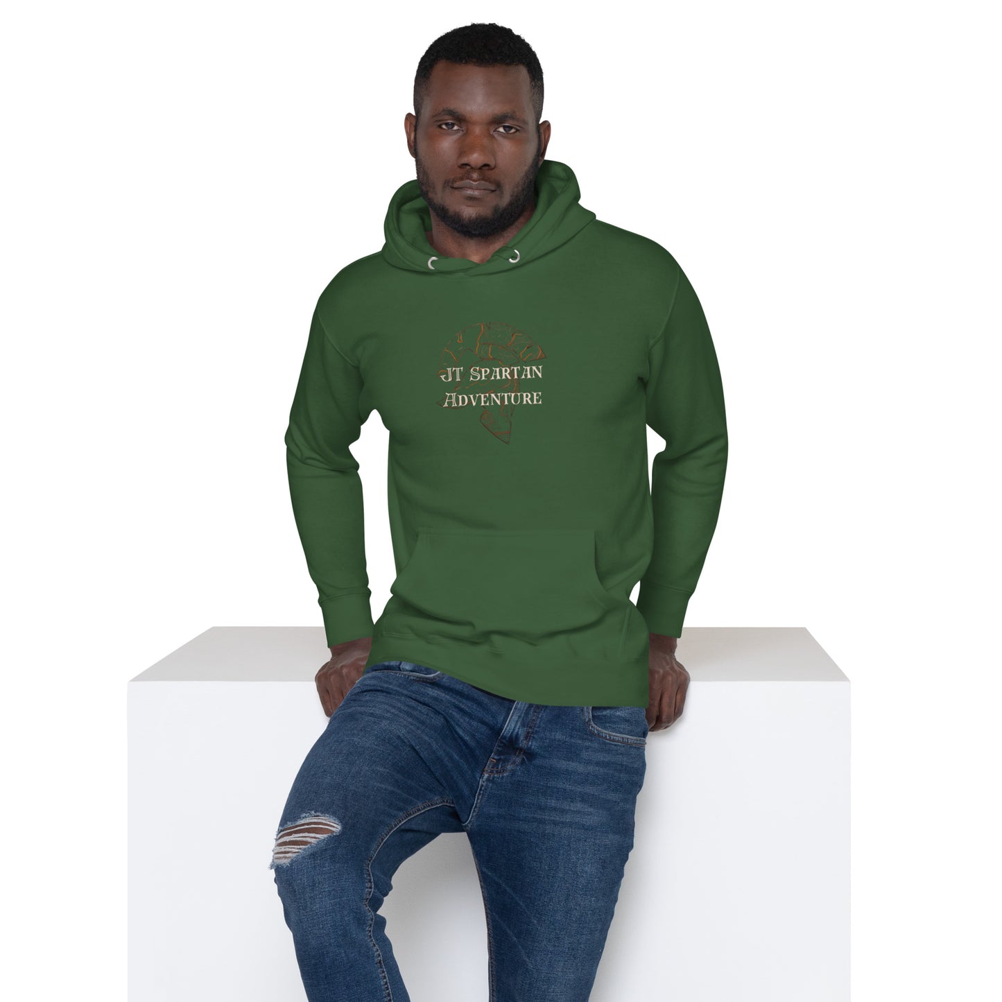 a man in a green hoodie sitting on a white block