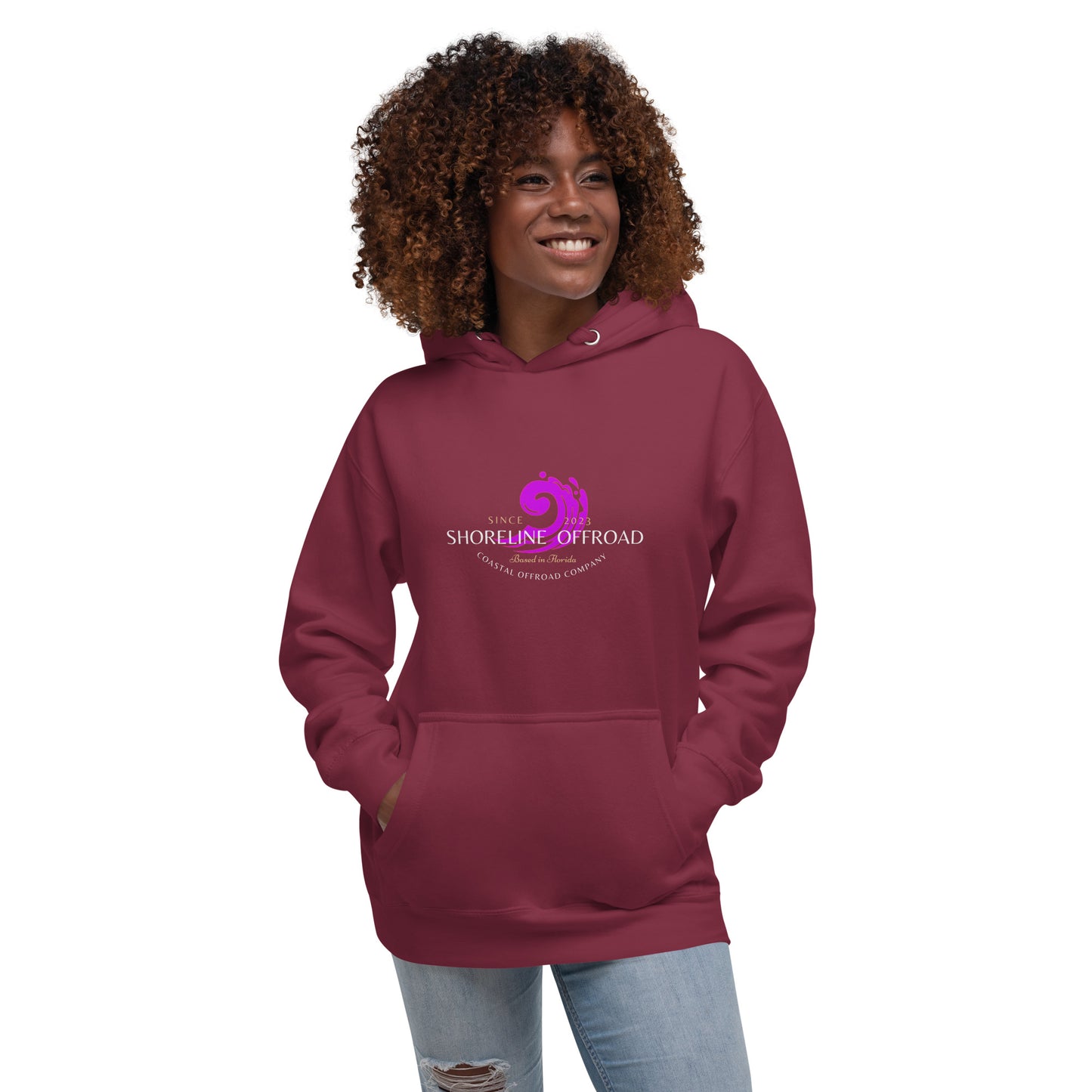 a woman wearing a maroon hoodie with the logo of a horse