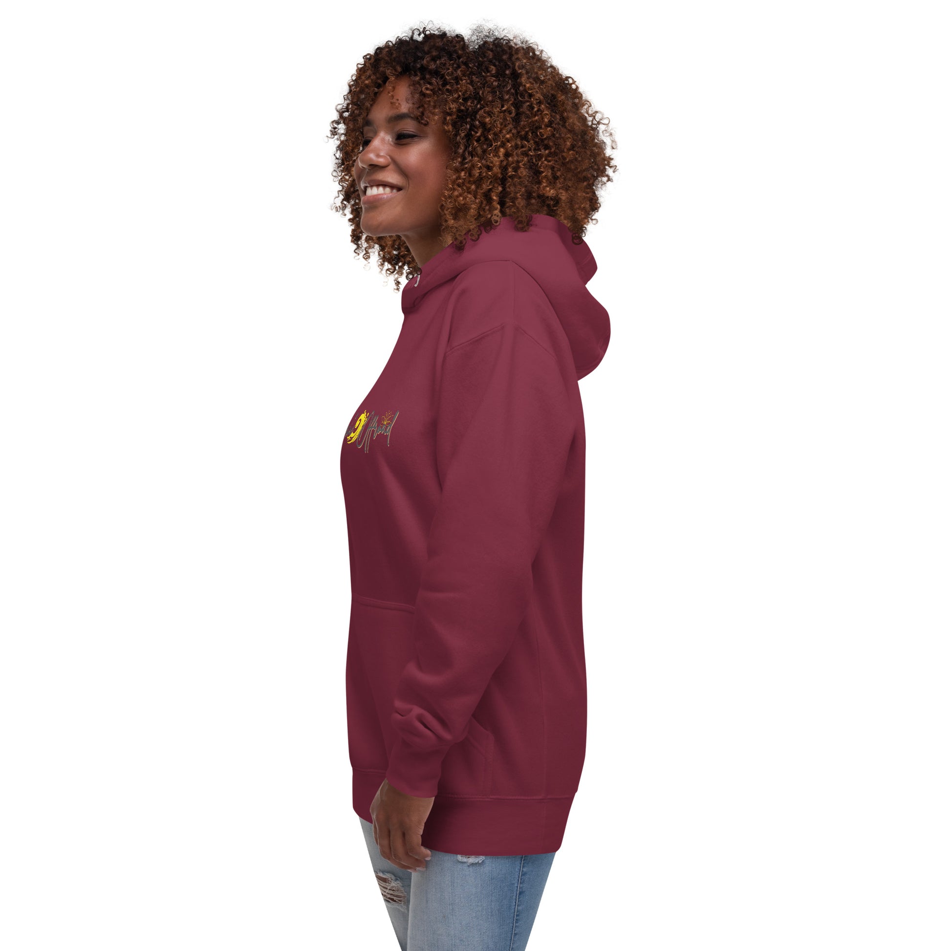 a woman wearing a maroon sweatshirt and jeans