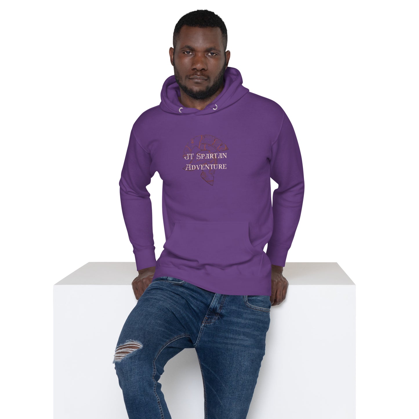 a man in a purple hoodie sitting on a white block