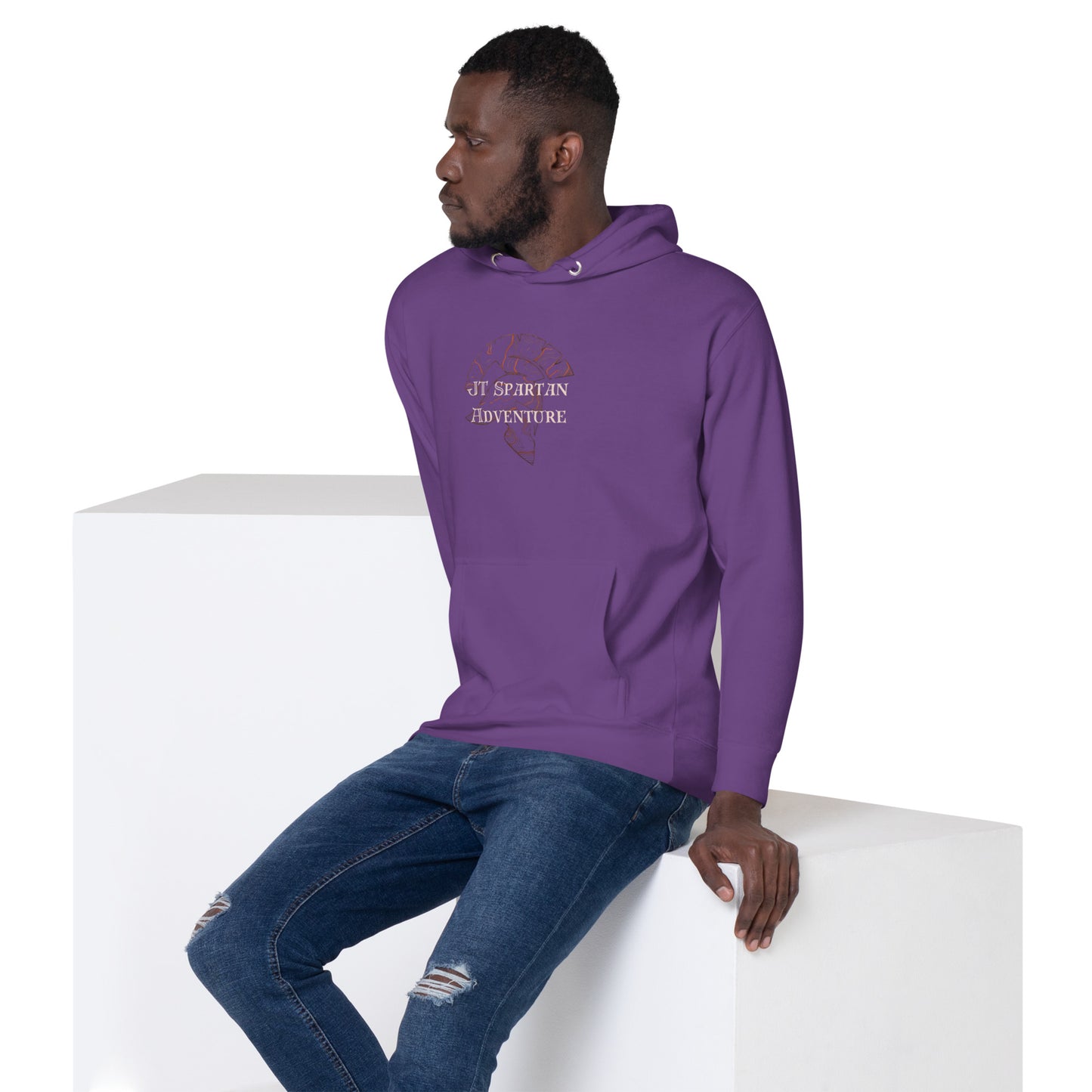 a man in a purple hoodie sitting on a white block