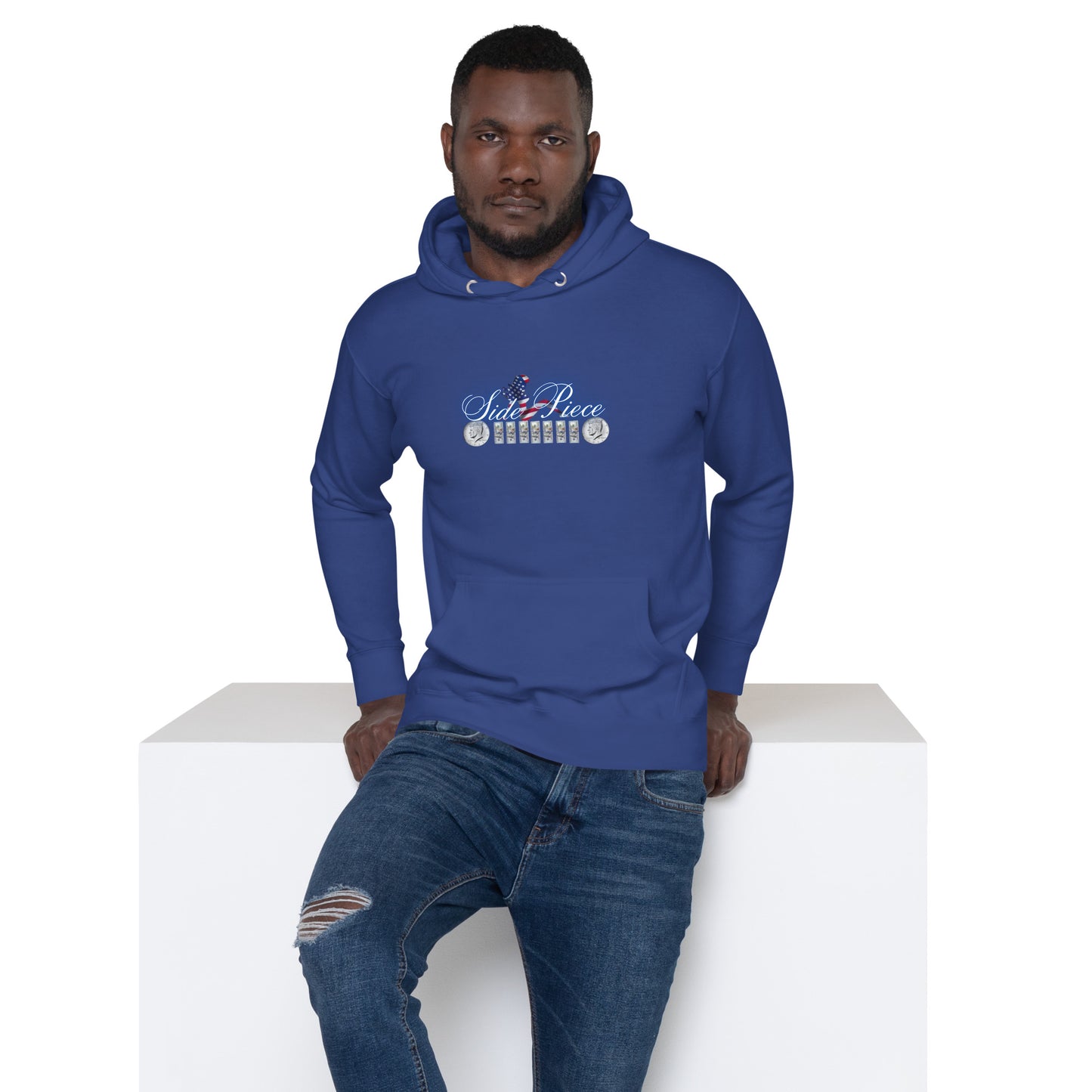 a man in a blue hoodie sitting on a white block