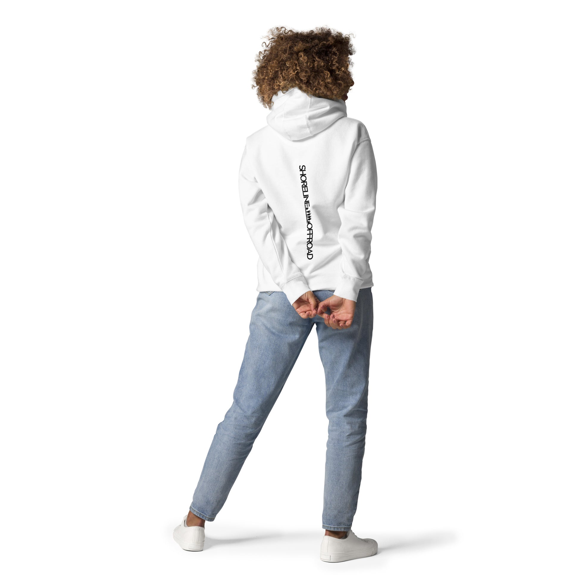 a woman wearing a white hoodie and jeans