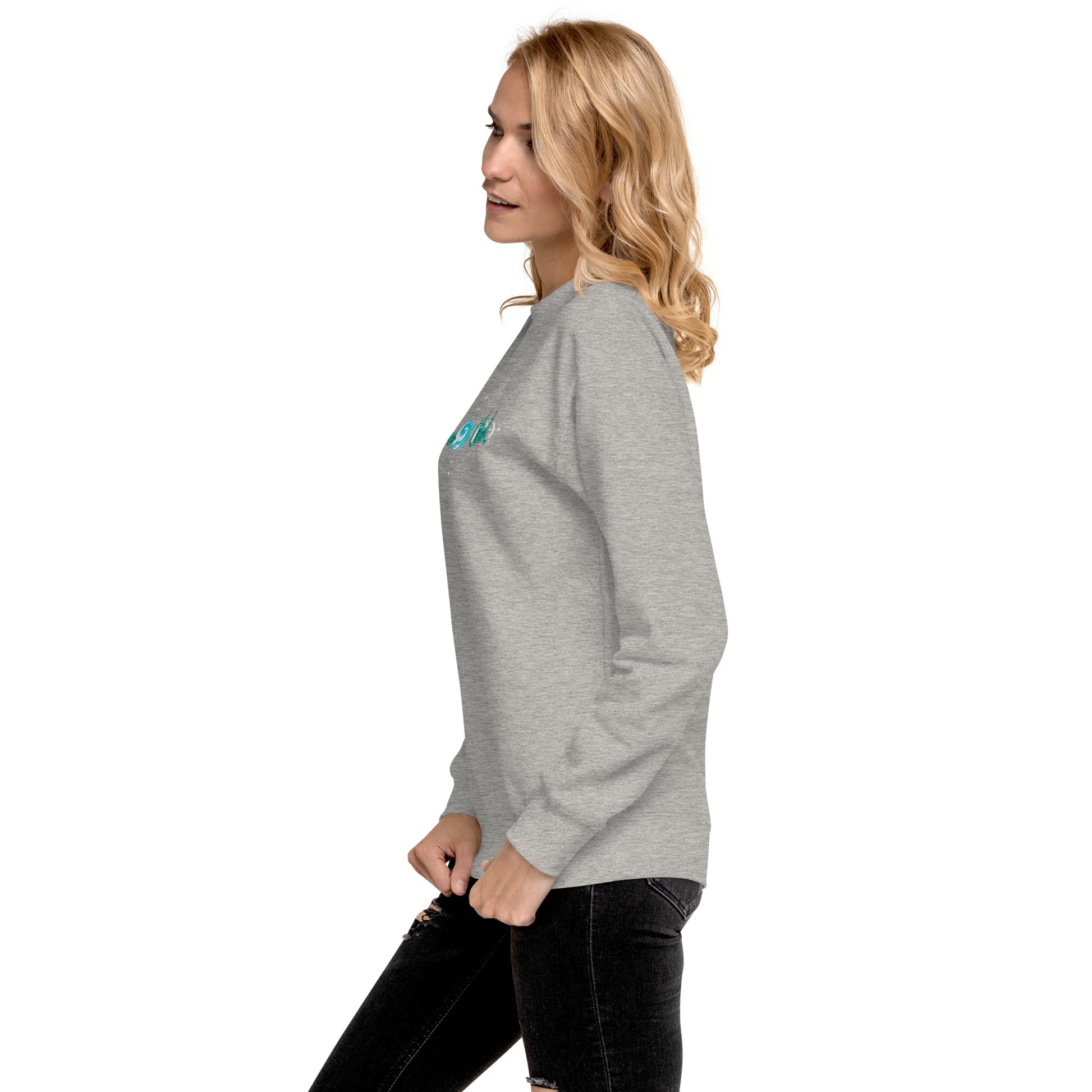 a woman wearing a grey sweatshirt and black jeans