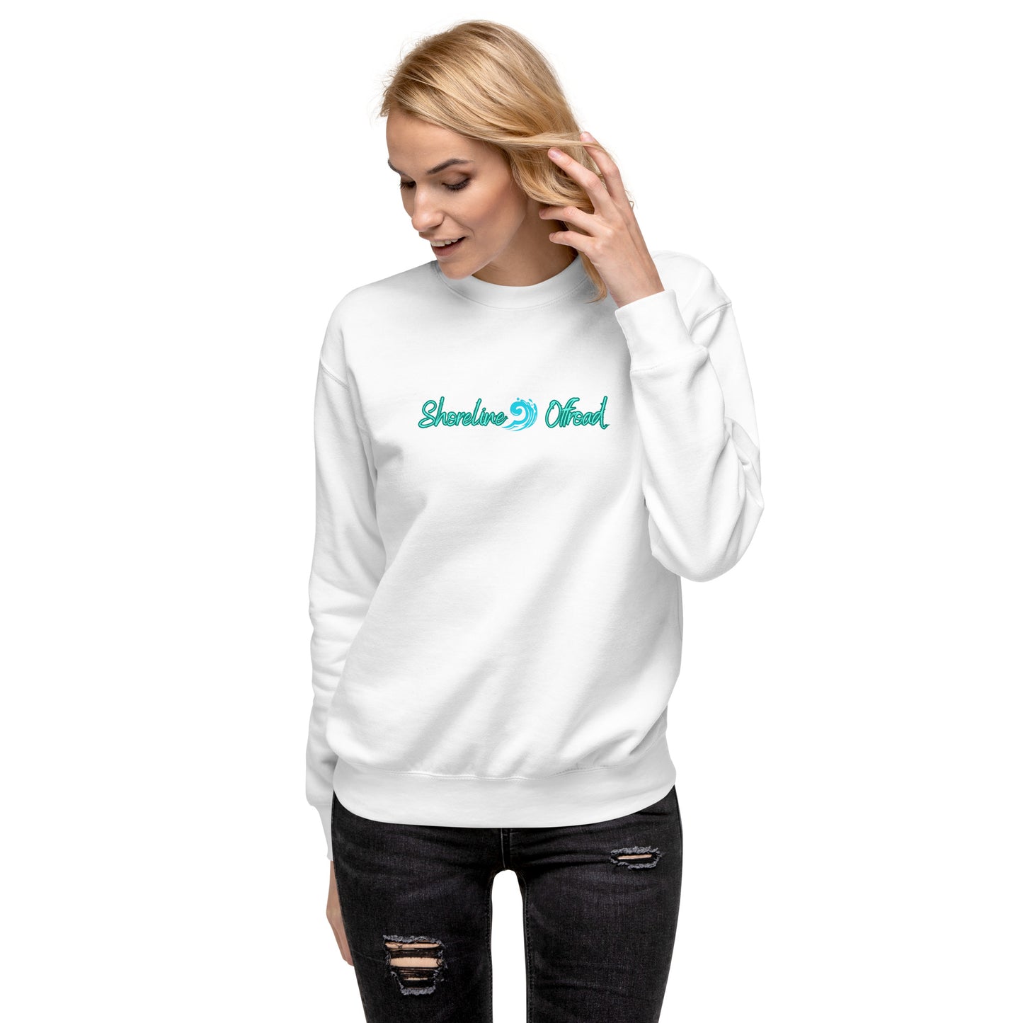 a woman wearing a white sweatshirt with a green logo