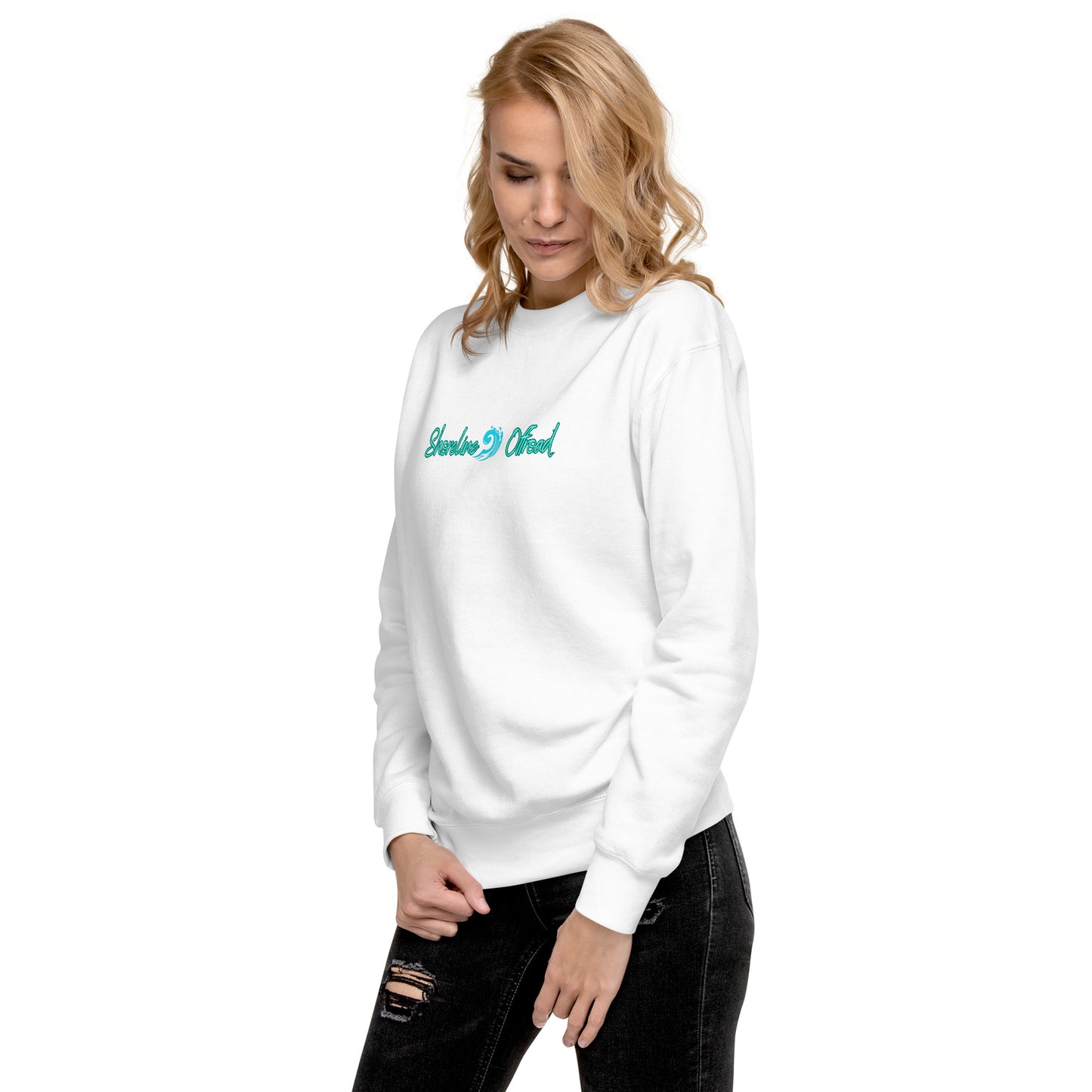 a woman wearing a white sweatshirt with a green logo