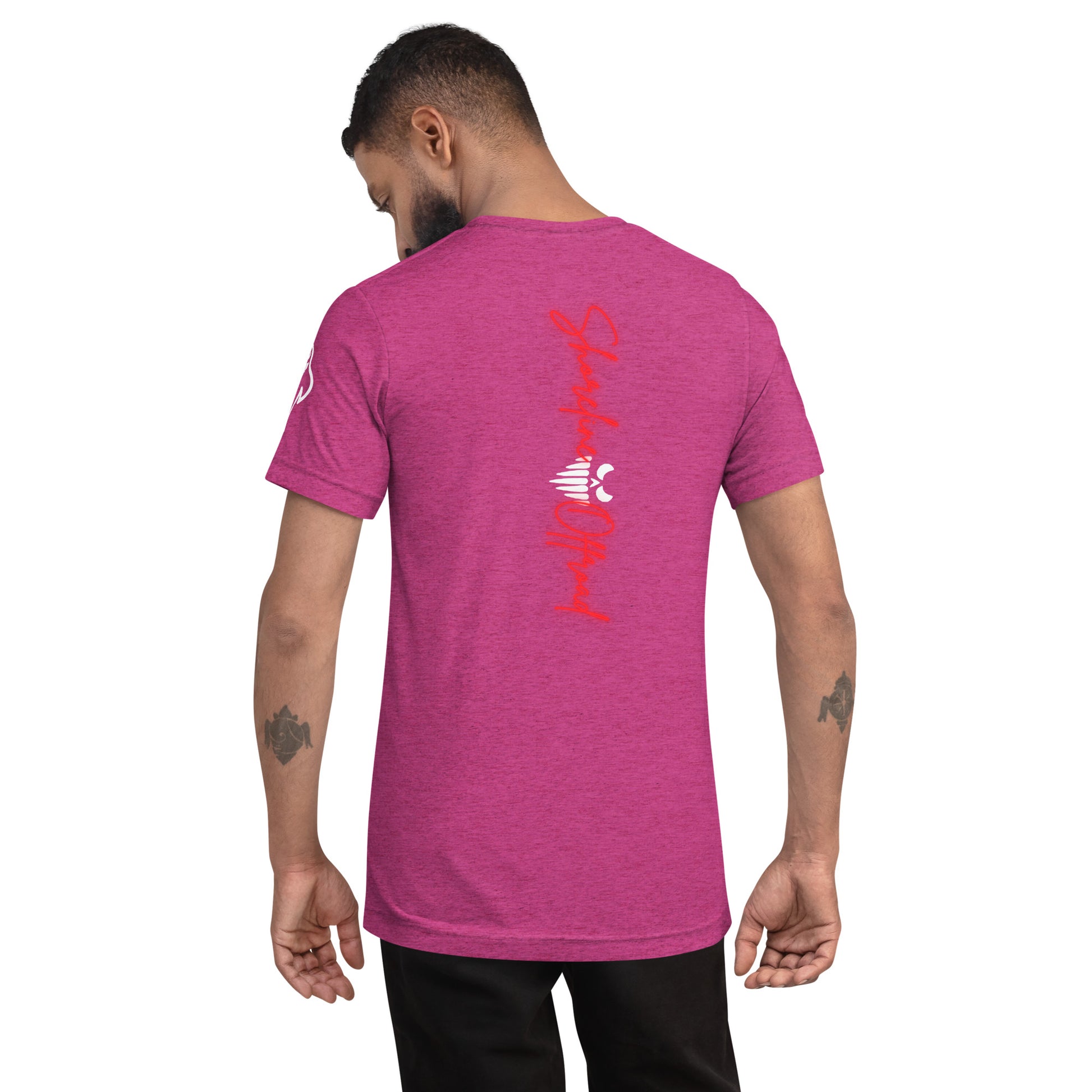 a man wearing a pink t - shirt with chinese writing on it