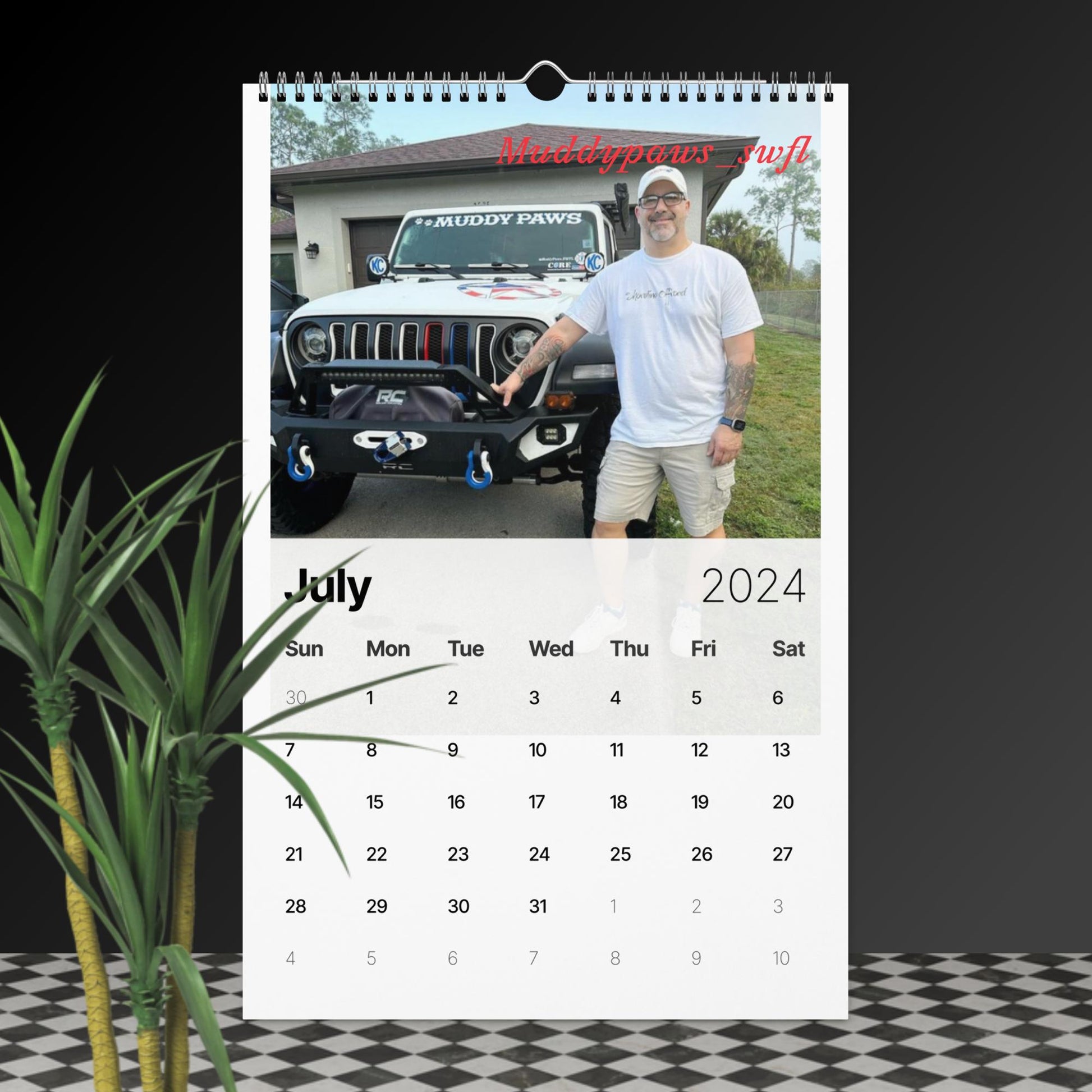 a calendar with a man standing next to a jeep