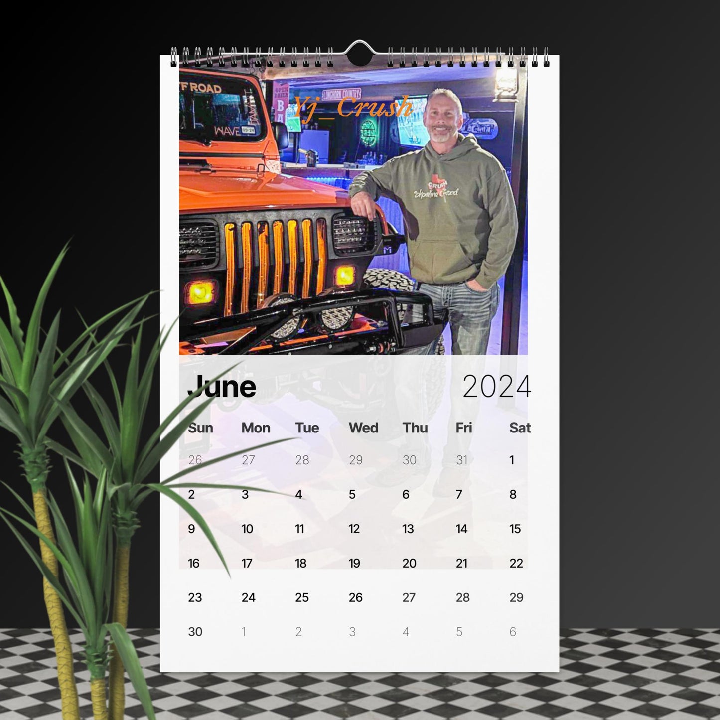 a calendar with a picture of a man standing next to a truck