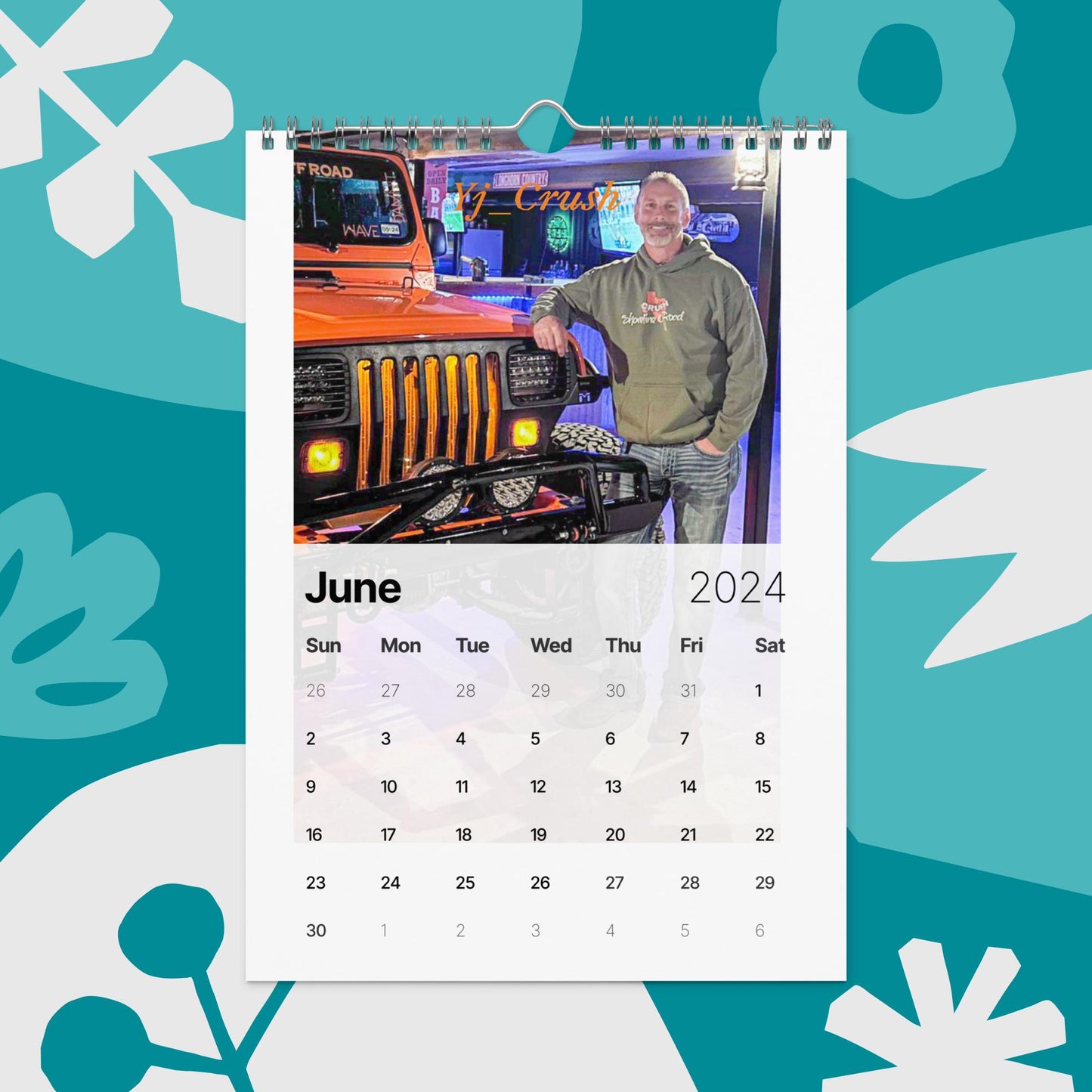 a calendar with a picture of a man standing next to a jeep