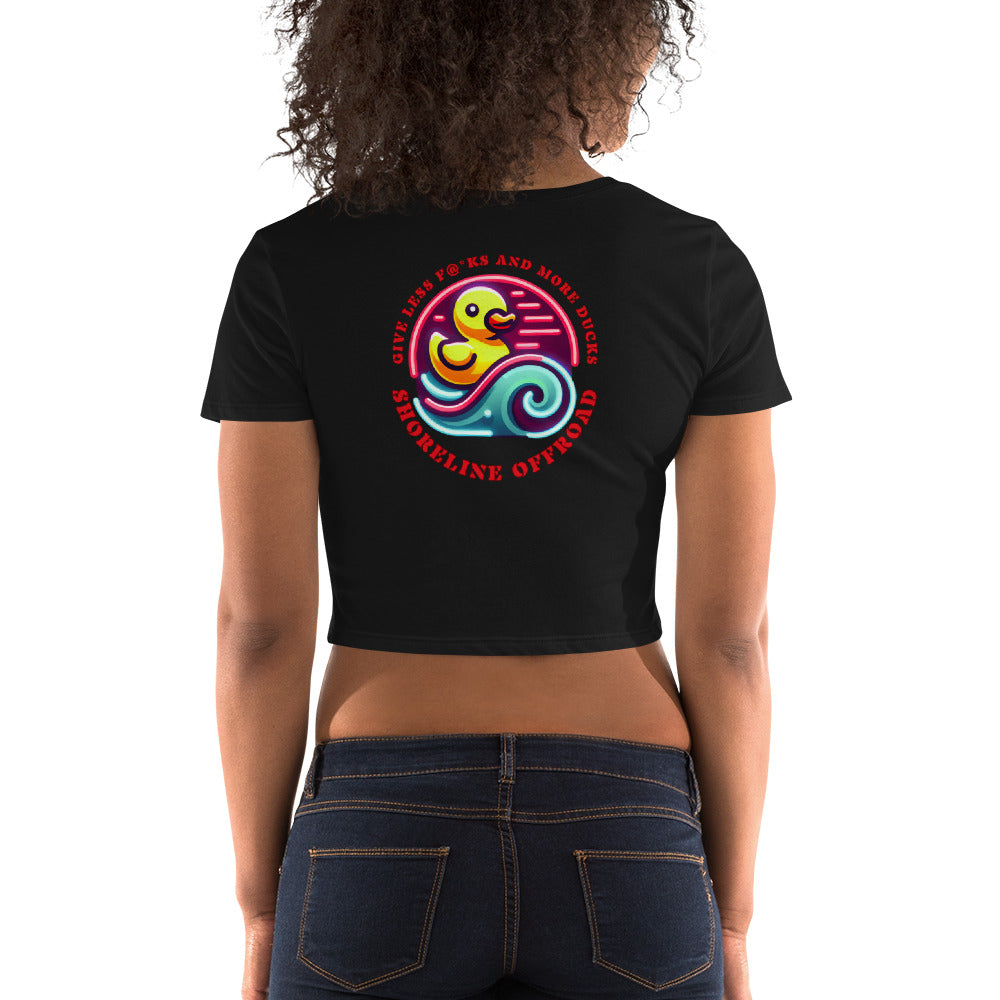 a woman wearing a black crop top with a colorful design on the back