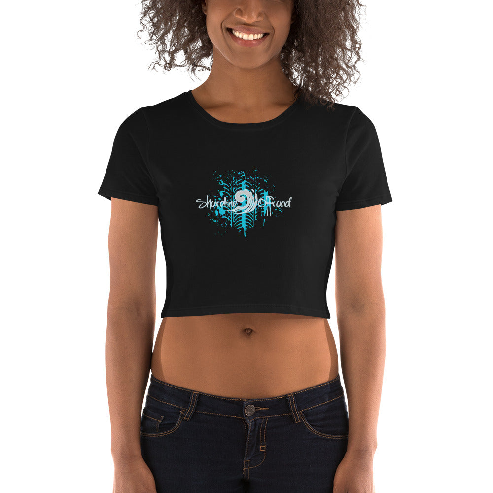 a woman wearing a black crop top with a blue design on it