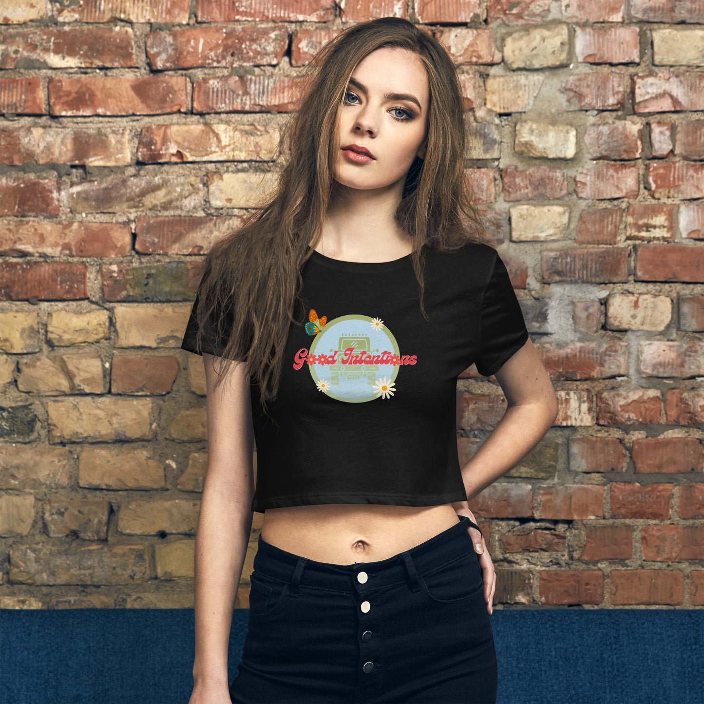 a woman standing in front of a brick wall