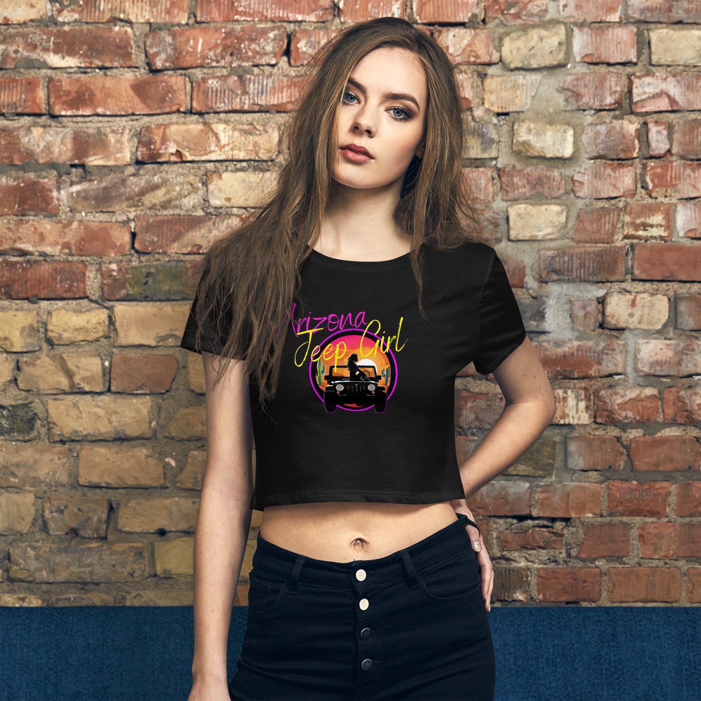 a woman standing in front of a brick wall