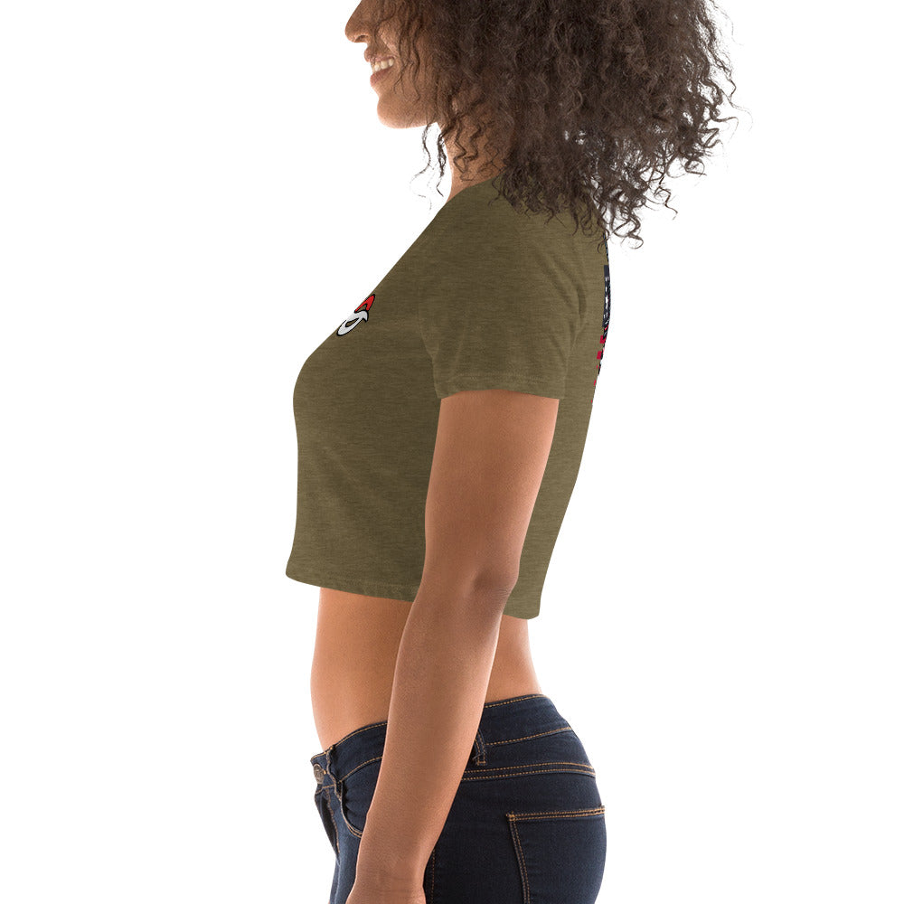 a woman wearing a green shirt and jeans