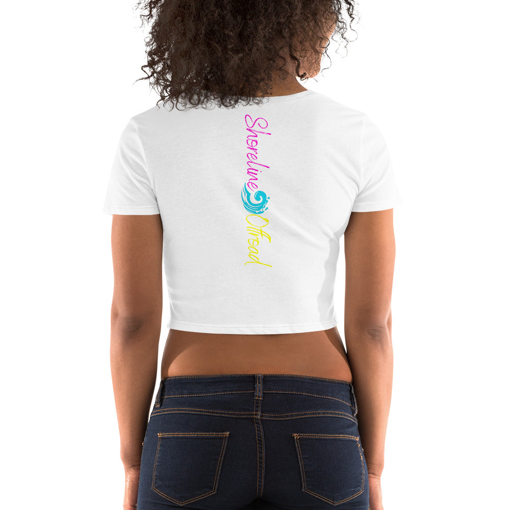 a woman wearing a white crop top with a rainbow print on the back