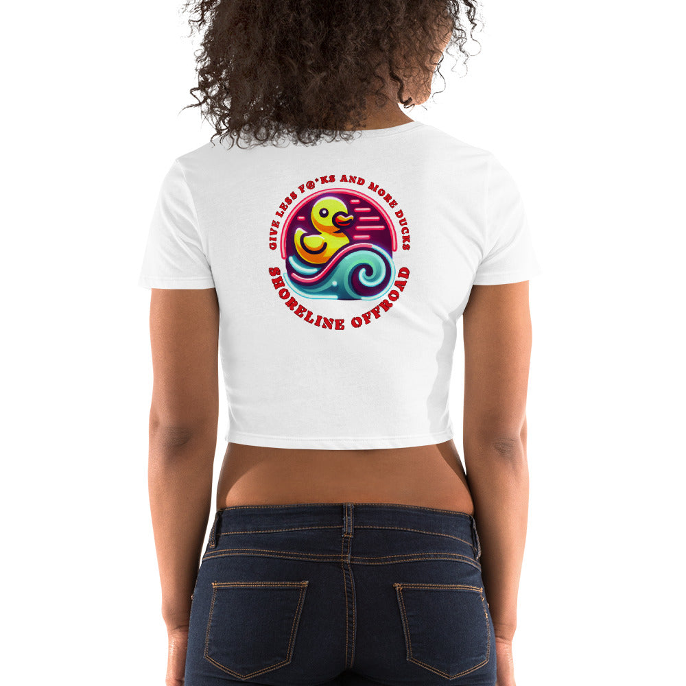 a woman wearing a white crop top with a colorful design on the back