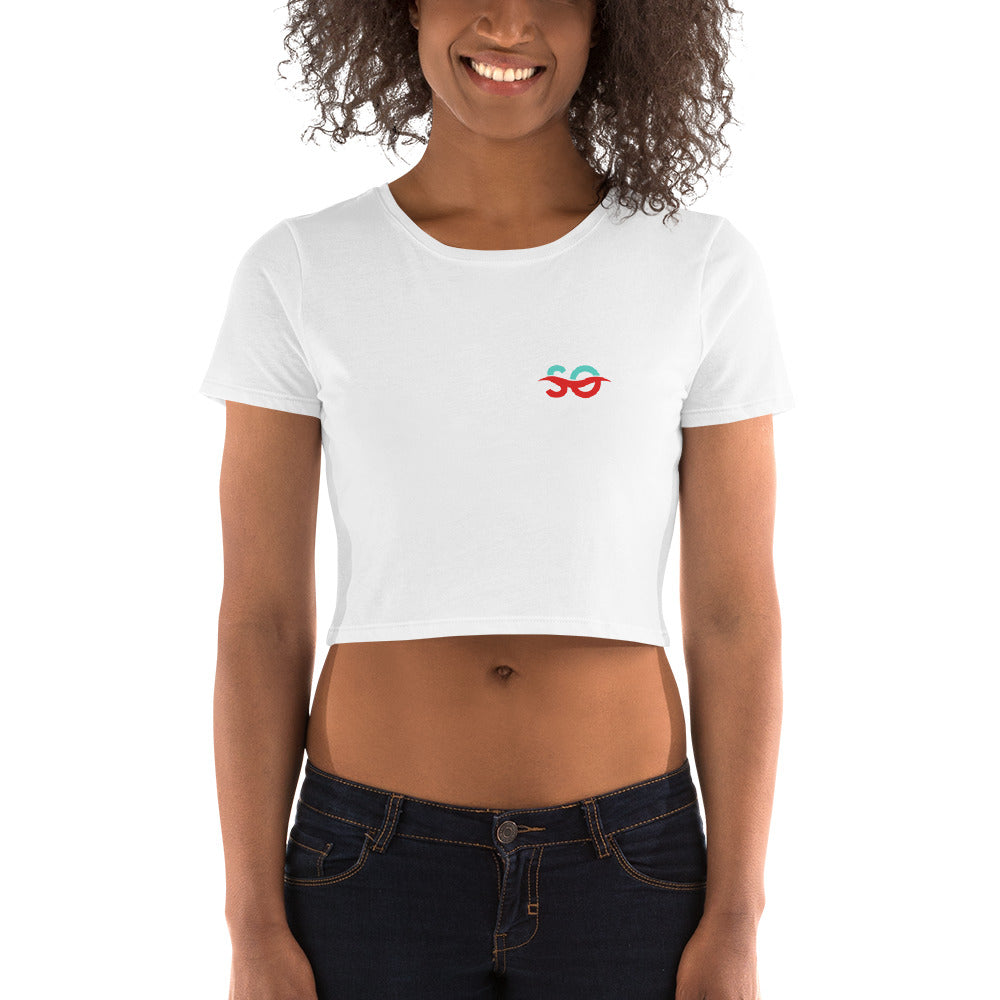 a woman wearing a white crop top with a red heart on it