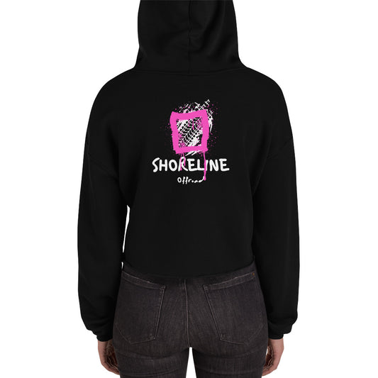 a woman wearing a black hoodie with a pink heart on it