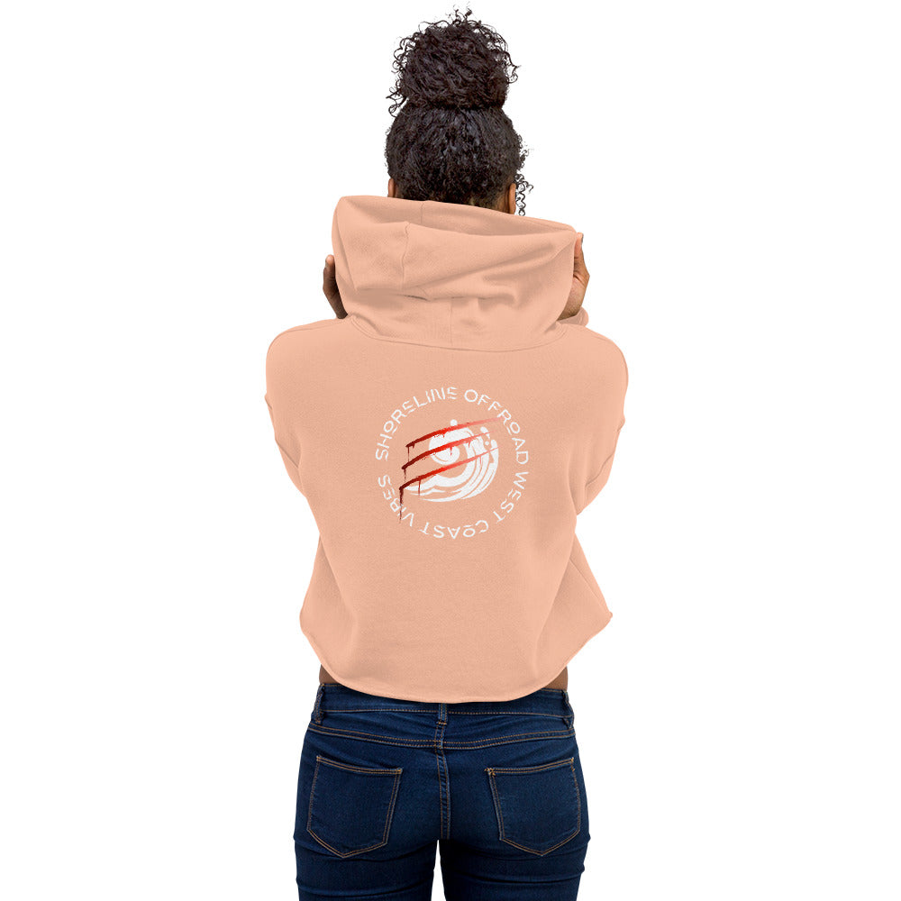 a woman wearing a pink hoodie with a logo on it