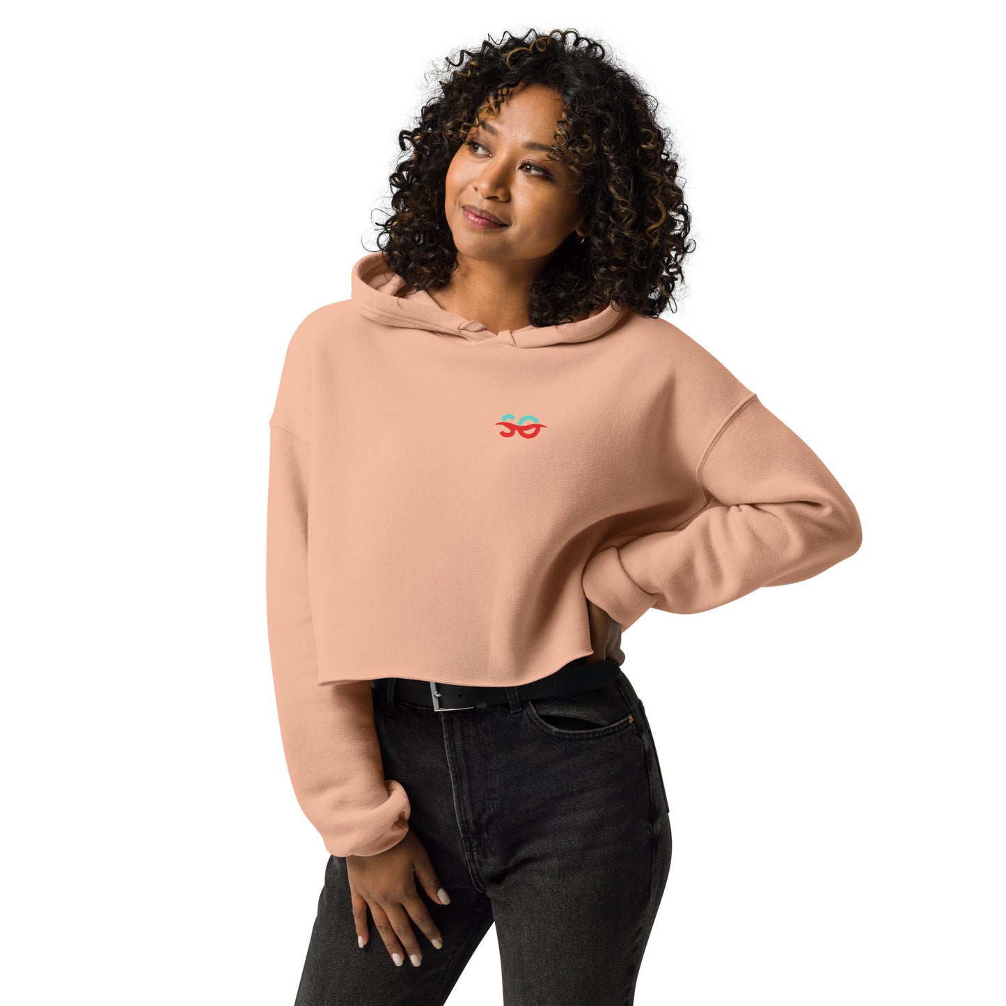 a woman wearing a pink sweatshirt and jeans