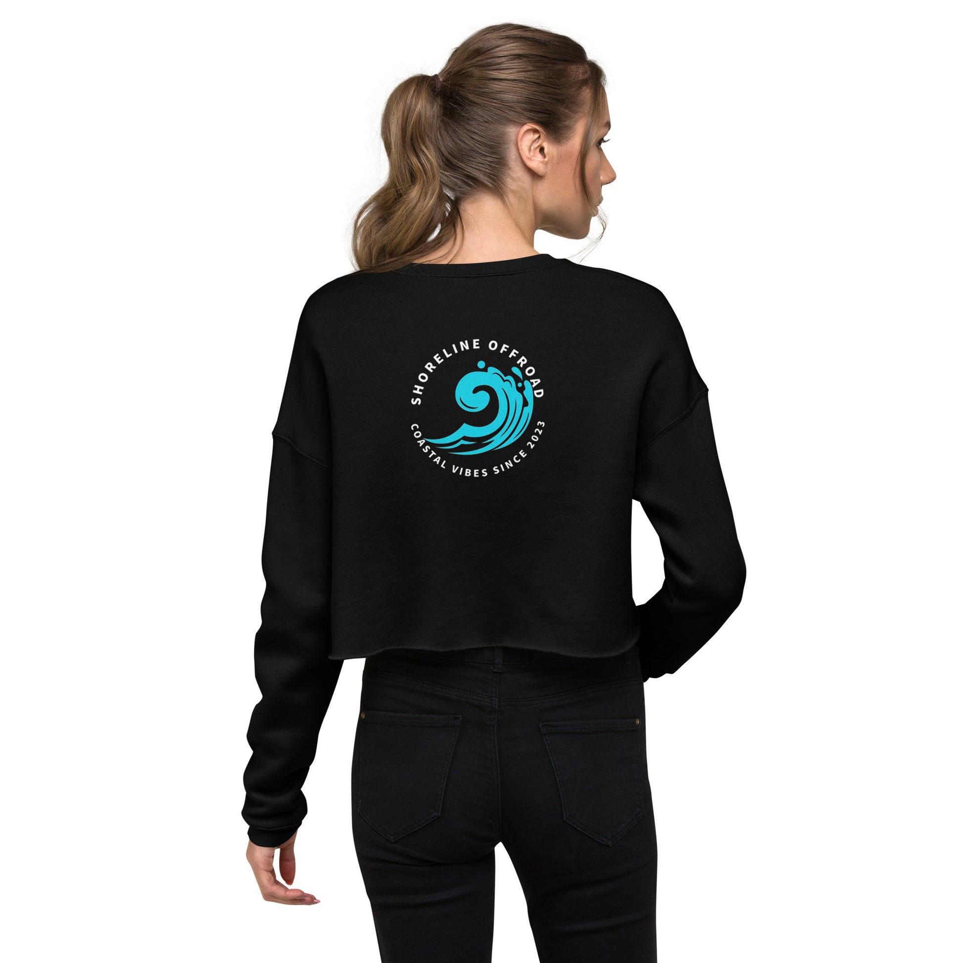 a woman wearing a black sweatshirt with a blue wave on it