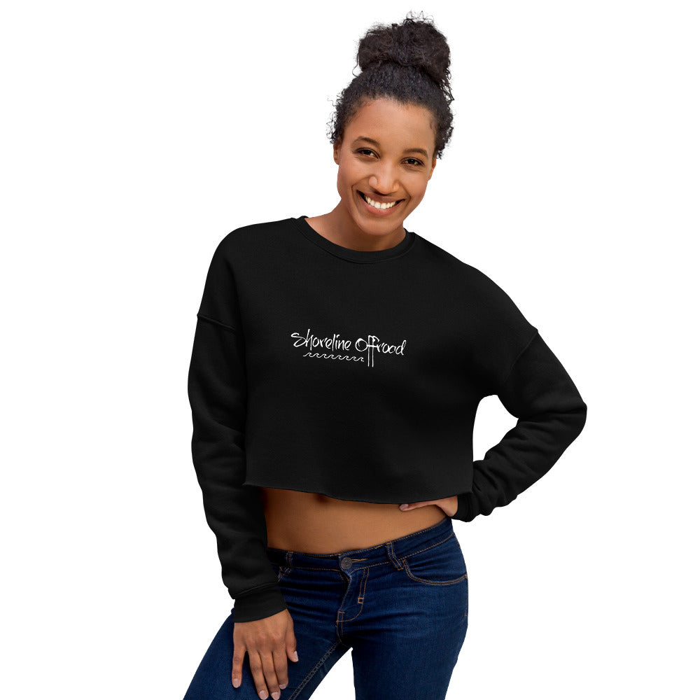 a smiling woman wearing a black crop top