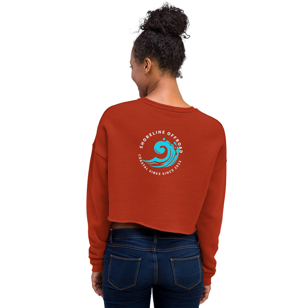 a woman wearing a red sweatshirt with a blue wave on it