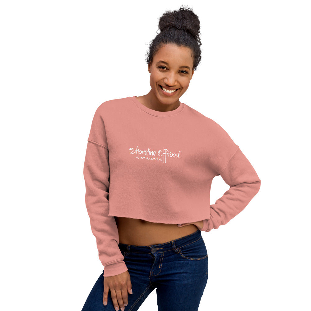 a smiling woman wearing a pink crop top