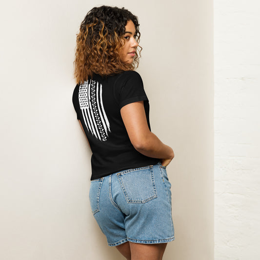 a woman leaning against a wall with her back to the camera