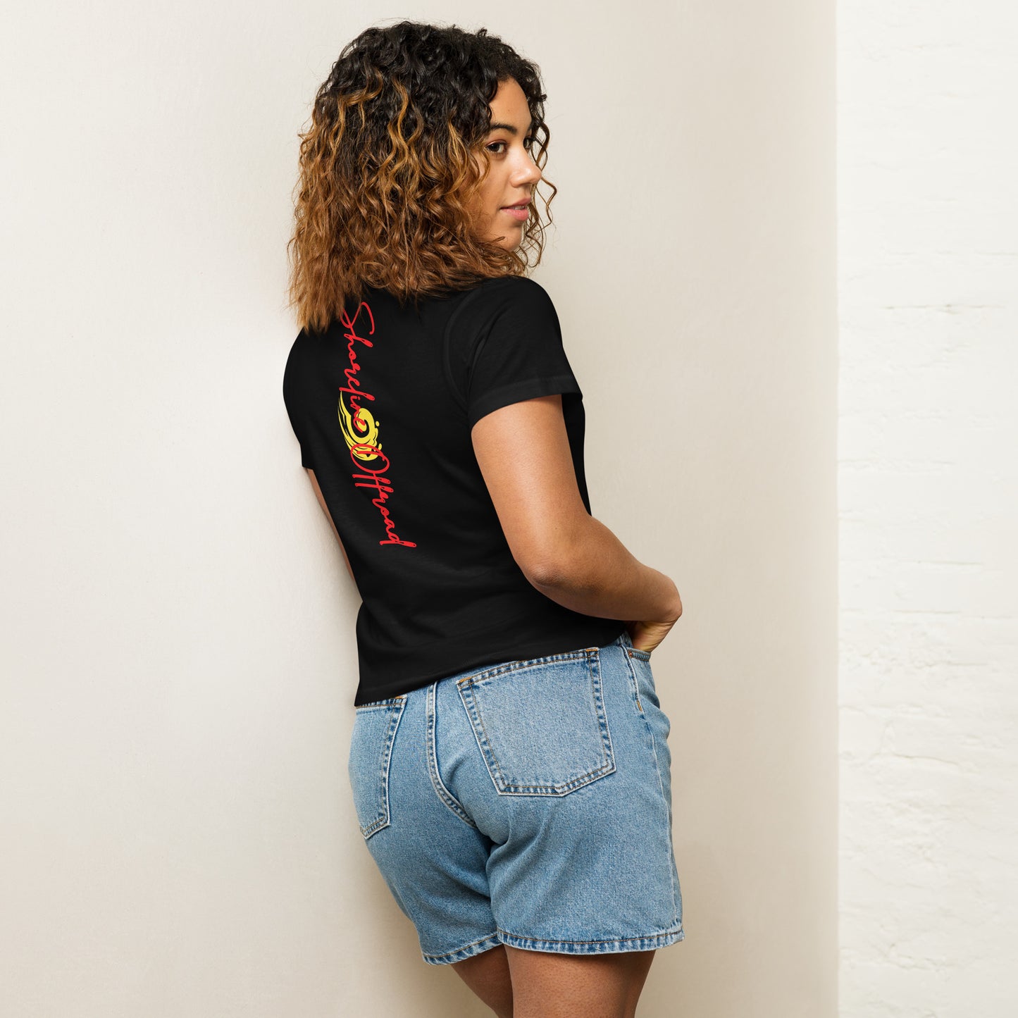 a woman leaning against a wall with her back to the wall