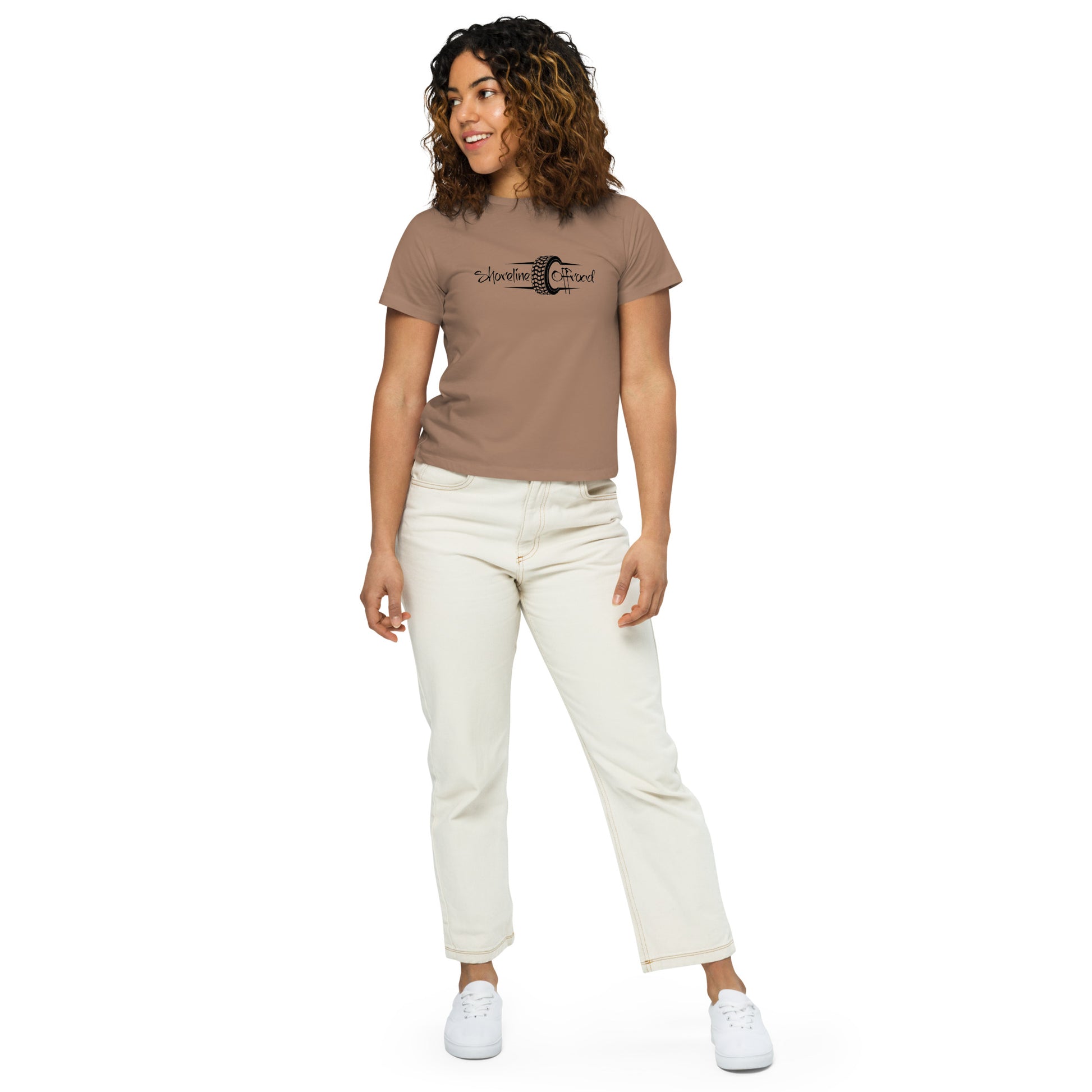 a woman wearing a brown shirt and white pants