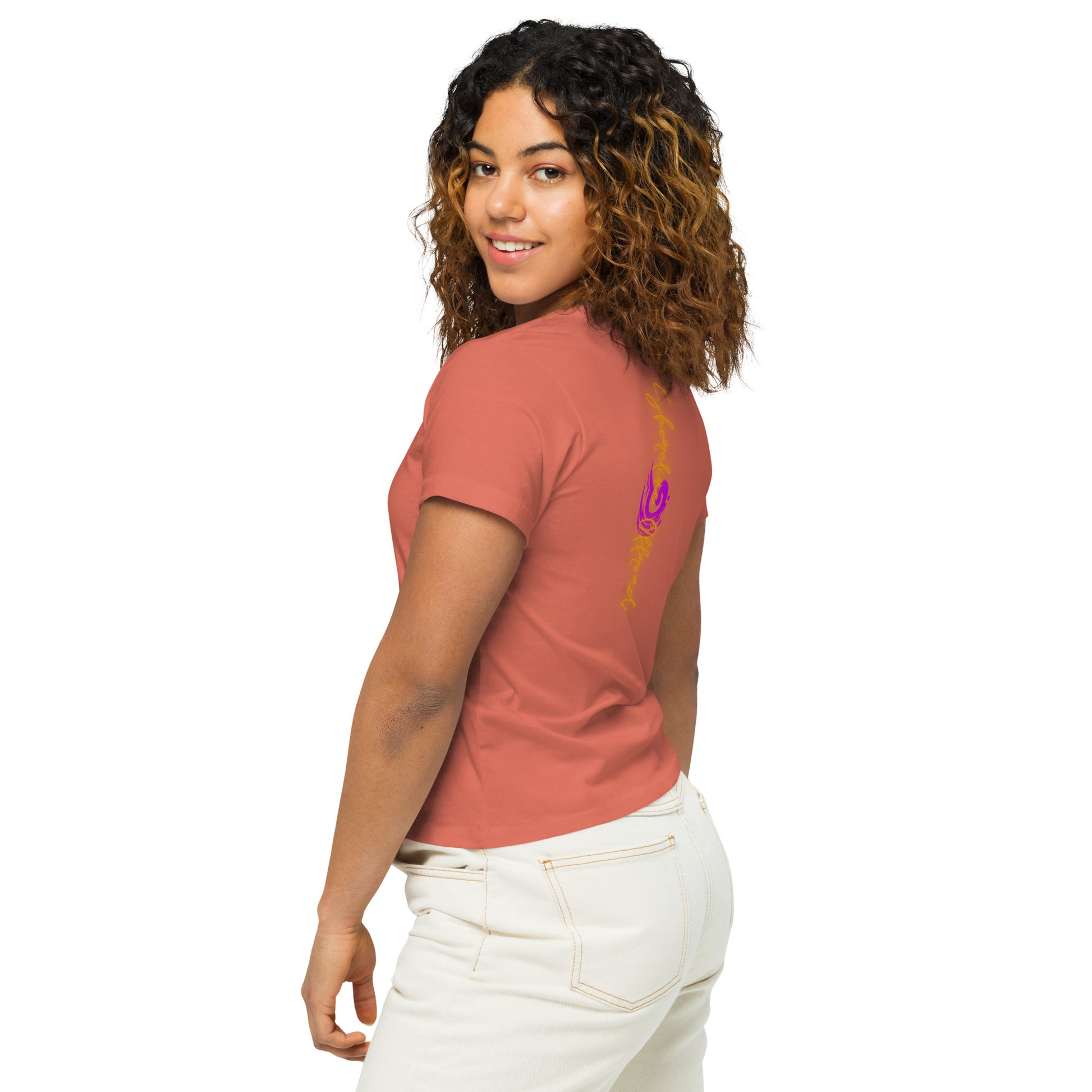 a woman with curly hair wearing a pink shirt