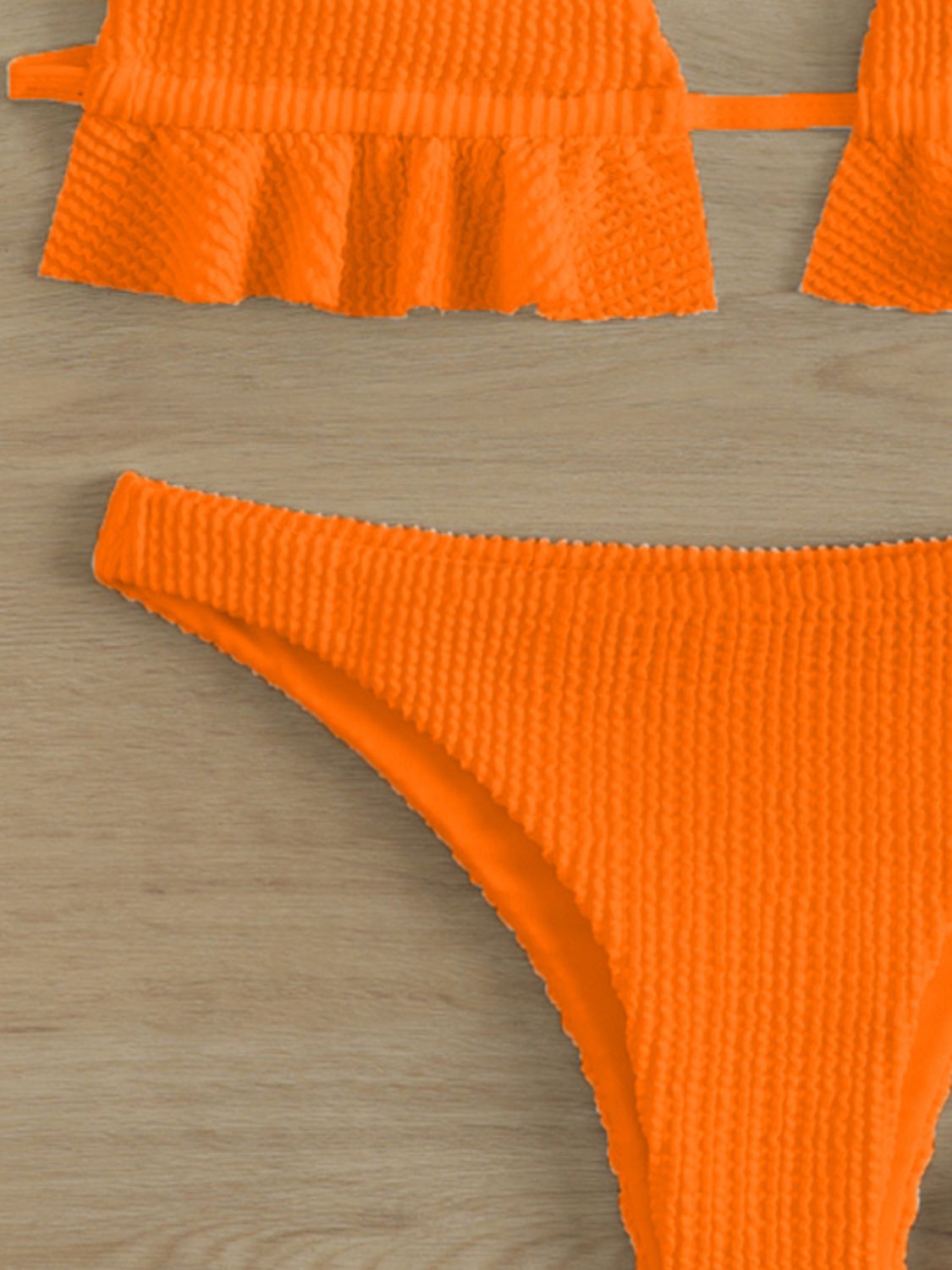 an orange bikini top and bottom with ruffles