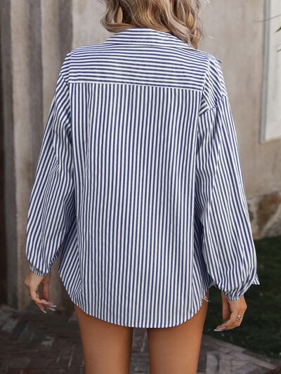 a woman wearing a blue and white striped shirt