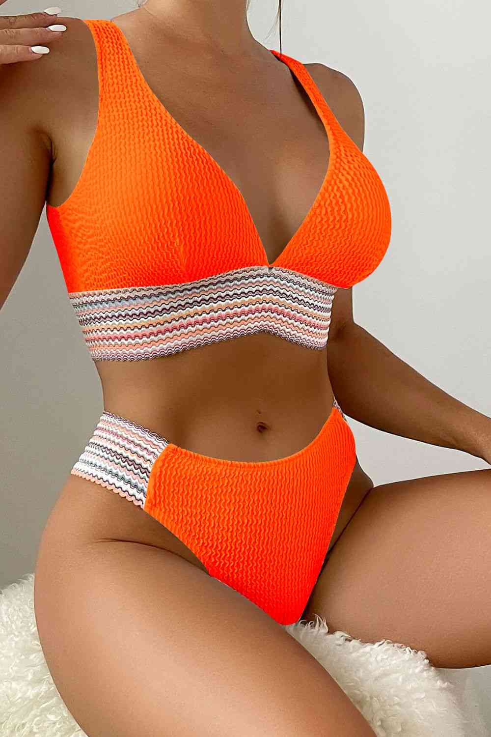 a woman in an orange bikini top and matching panties