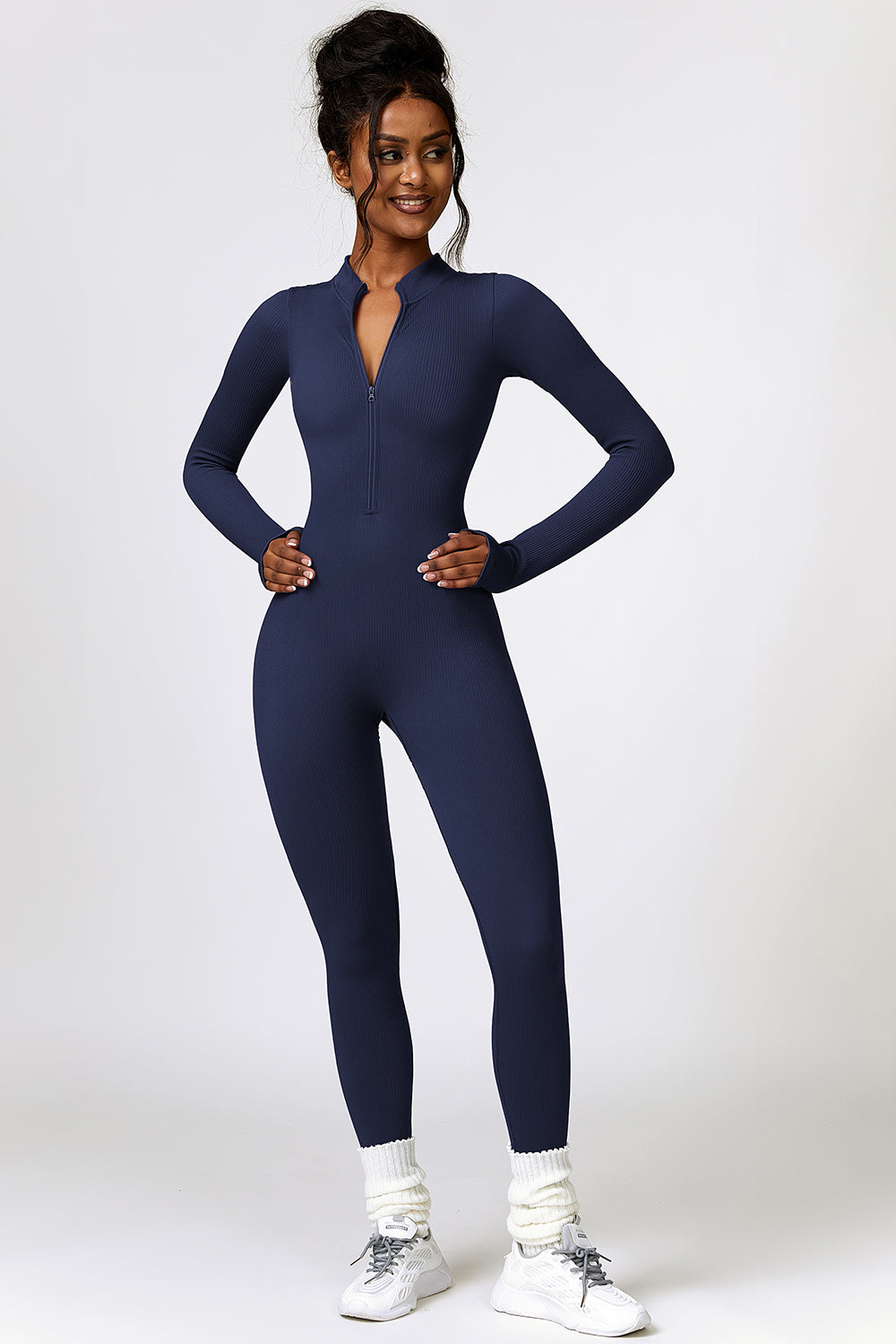a woman in a blue jumpsuit posing for a picture