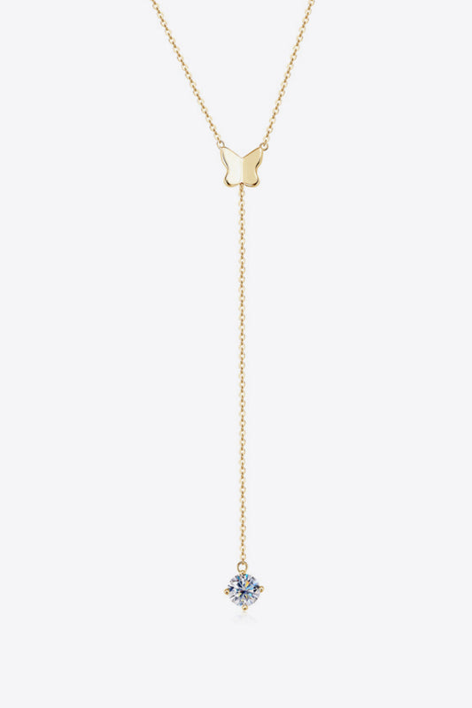 a gold necklace with a blue flower on it
