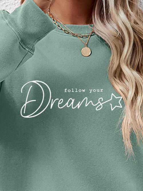 a woman wearing a green sweatshirt that says follow your dreams