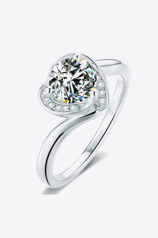 a heart shaped diamond ring on a white background